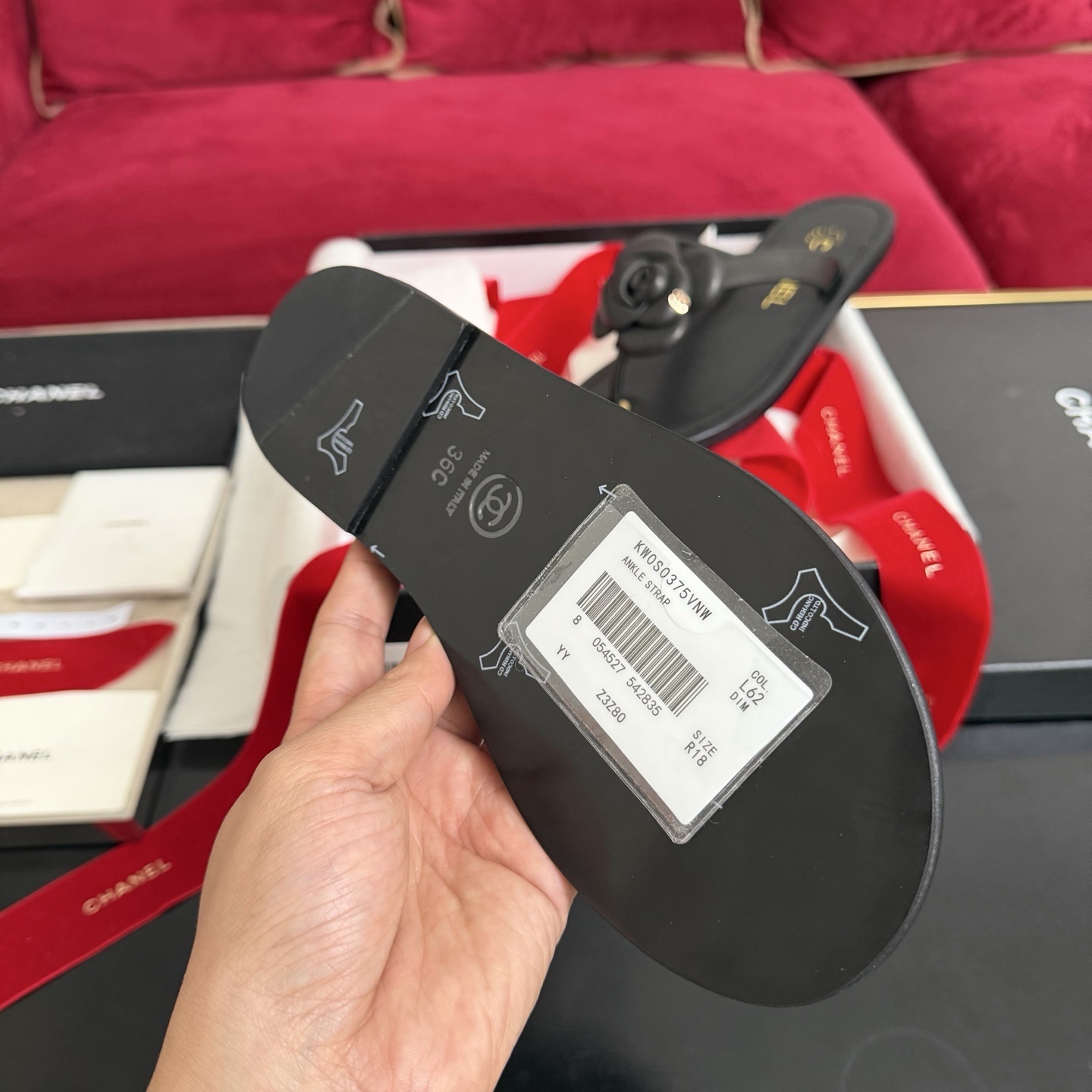 Black Chanel leather thong sandals with 3D Camellia flower and gold CC logo in a luxury gift box with red ribbons. - Hình 9