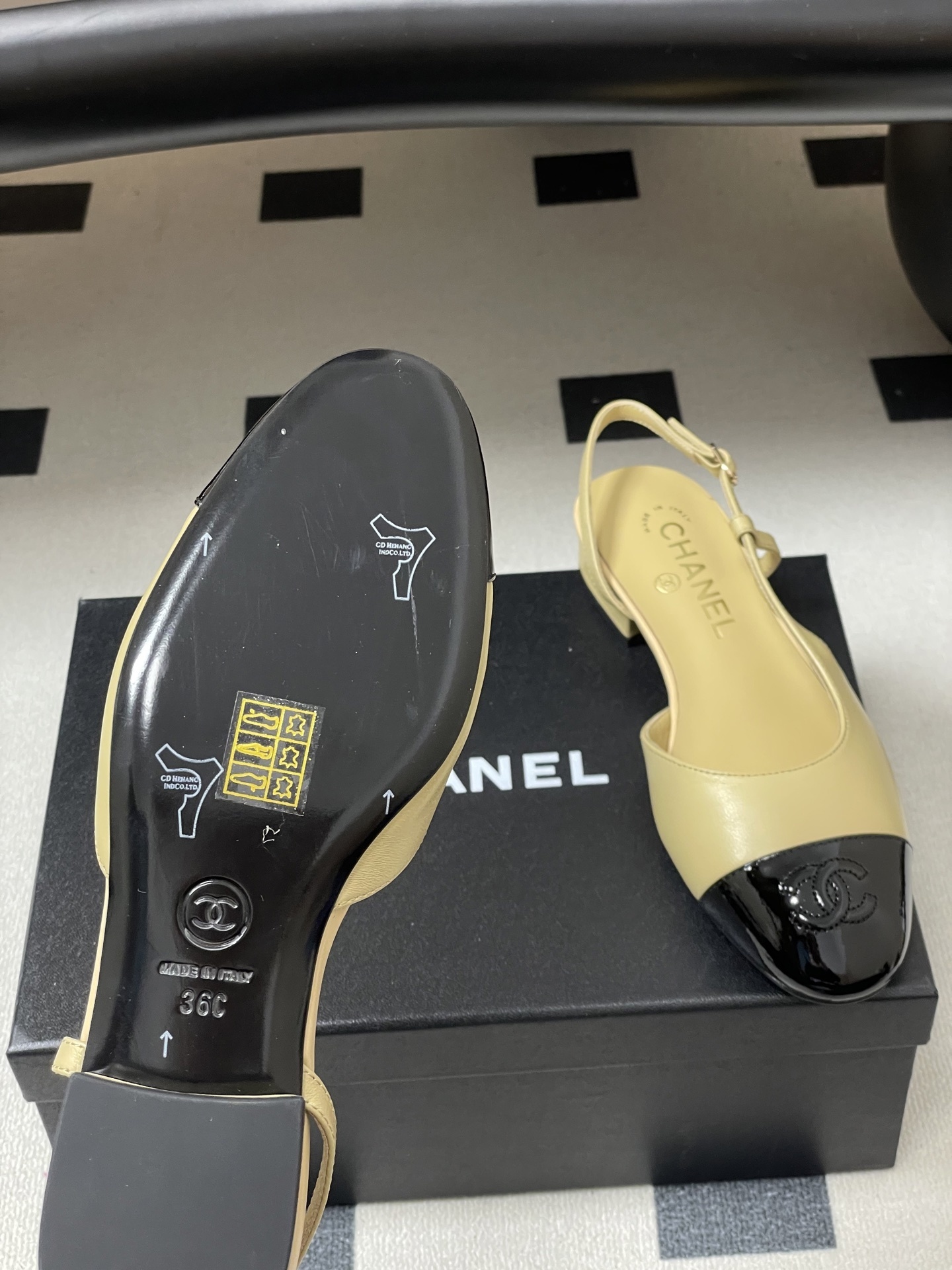 A pair of classic Chanel beige leather slingback pumps with black patent leather cap toes and low block heels. - Hình 8
