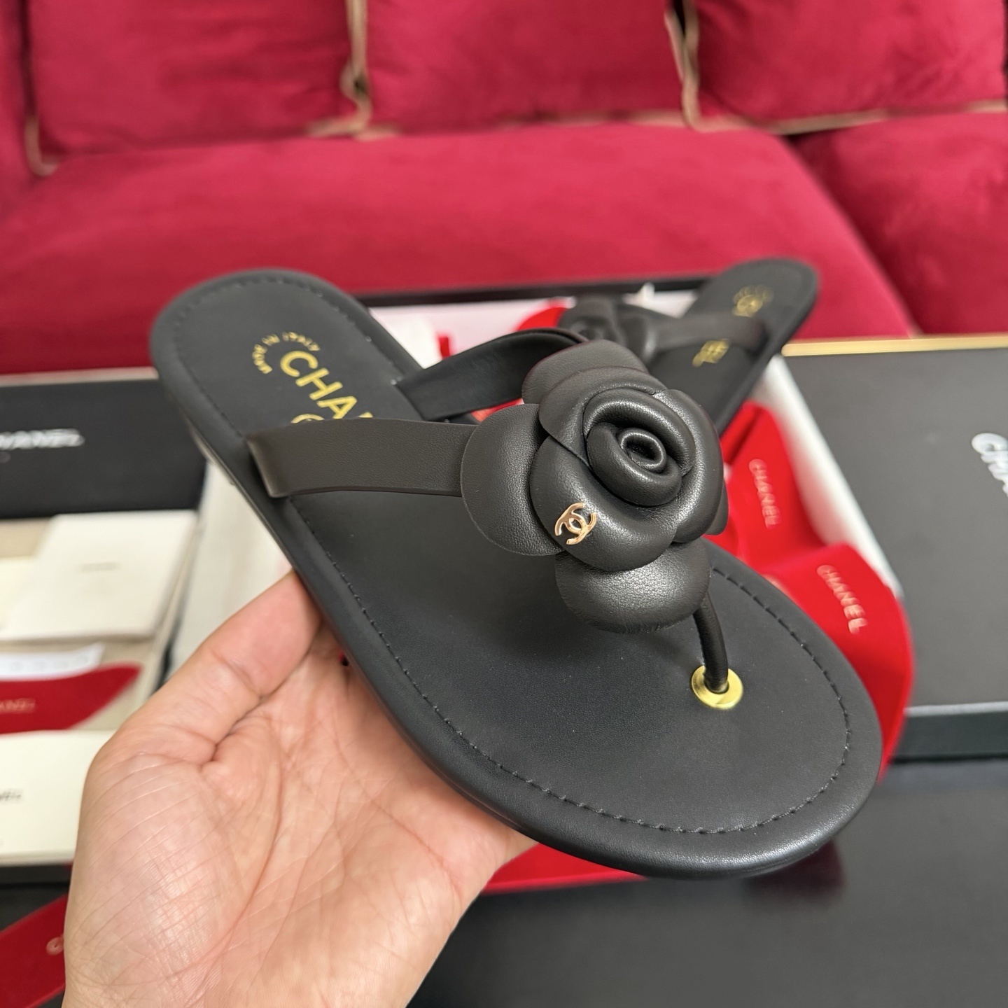 Black Chanel Camellia thong sandals with 3D flower detail and gold CC logo in original packaging with red ribbon. - Hình 4