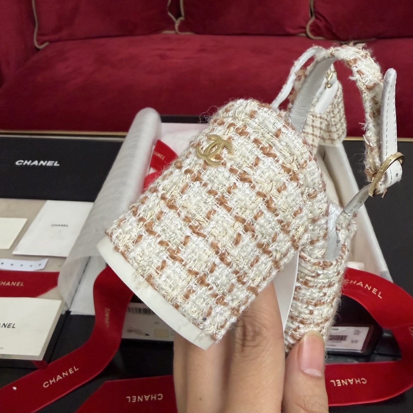 Luxury Chanel tweed slingback pumps with black cap toe and CC logo shown in original packaging with red ribbons. - Hình 8