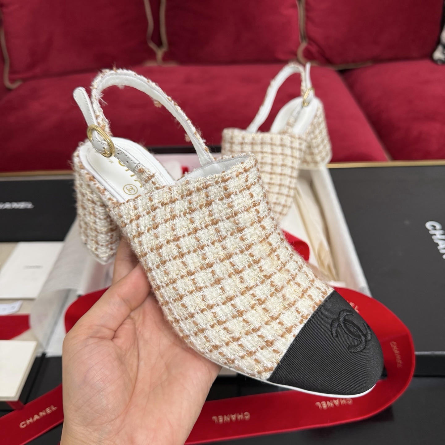 Luxury Chanel tweed slingback pumps with black cap toe and CC logo shown in original packaging with red ribbons. - Hình 4