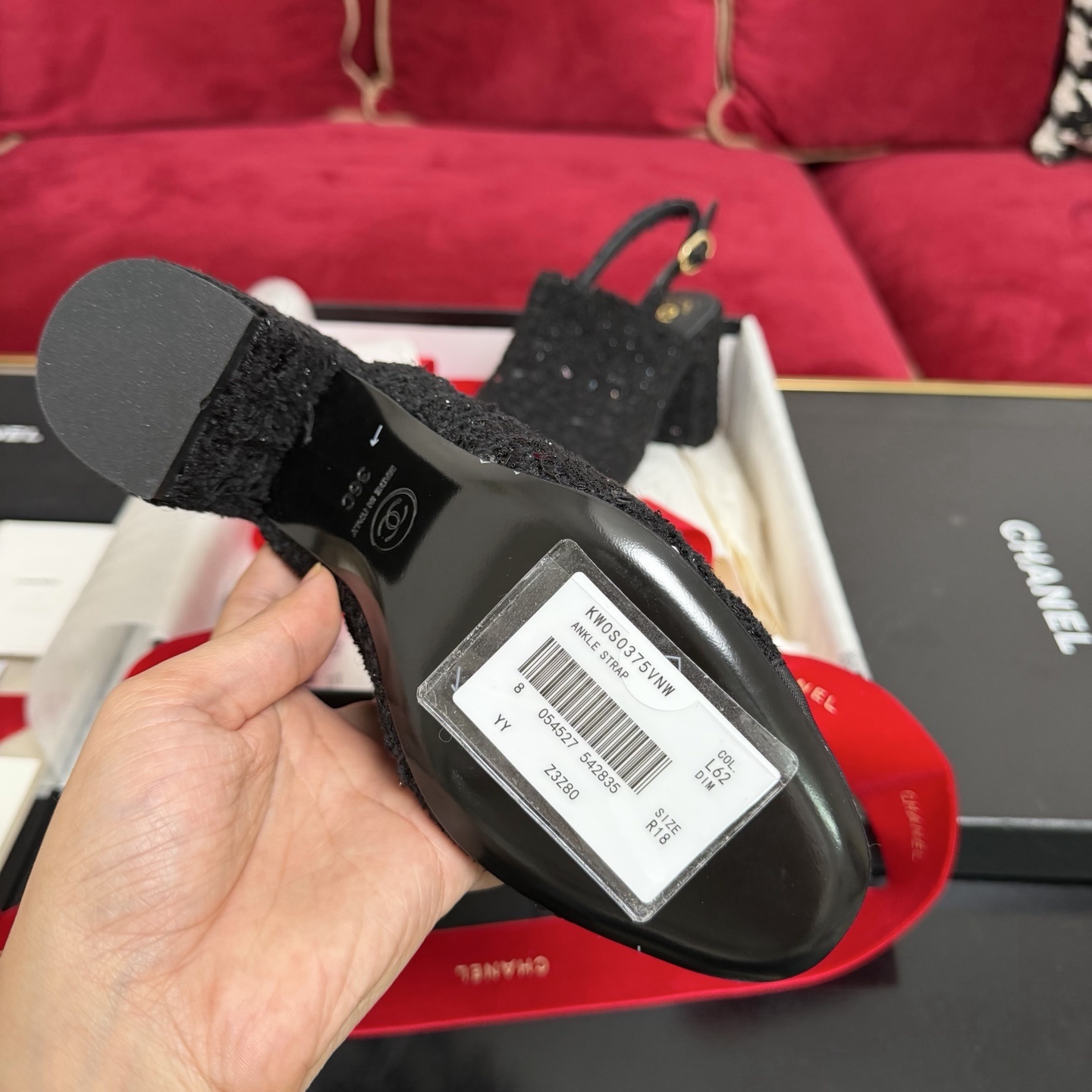 Pair of Chanel black tweed slingback pumps with sequins and CC logo on toe cap, displayed in original packaging with red ribbon. - Hình 9