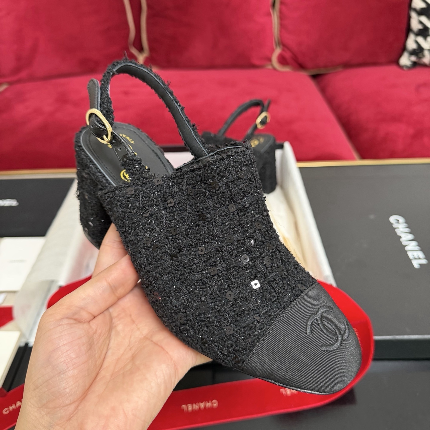 Pair of Chanel black tweed slingback pumps with sequins and CC logo on toe cap, displayed in original packaging with red ribbon. - Hình 4