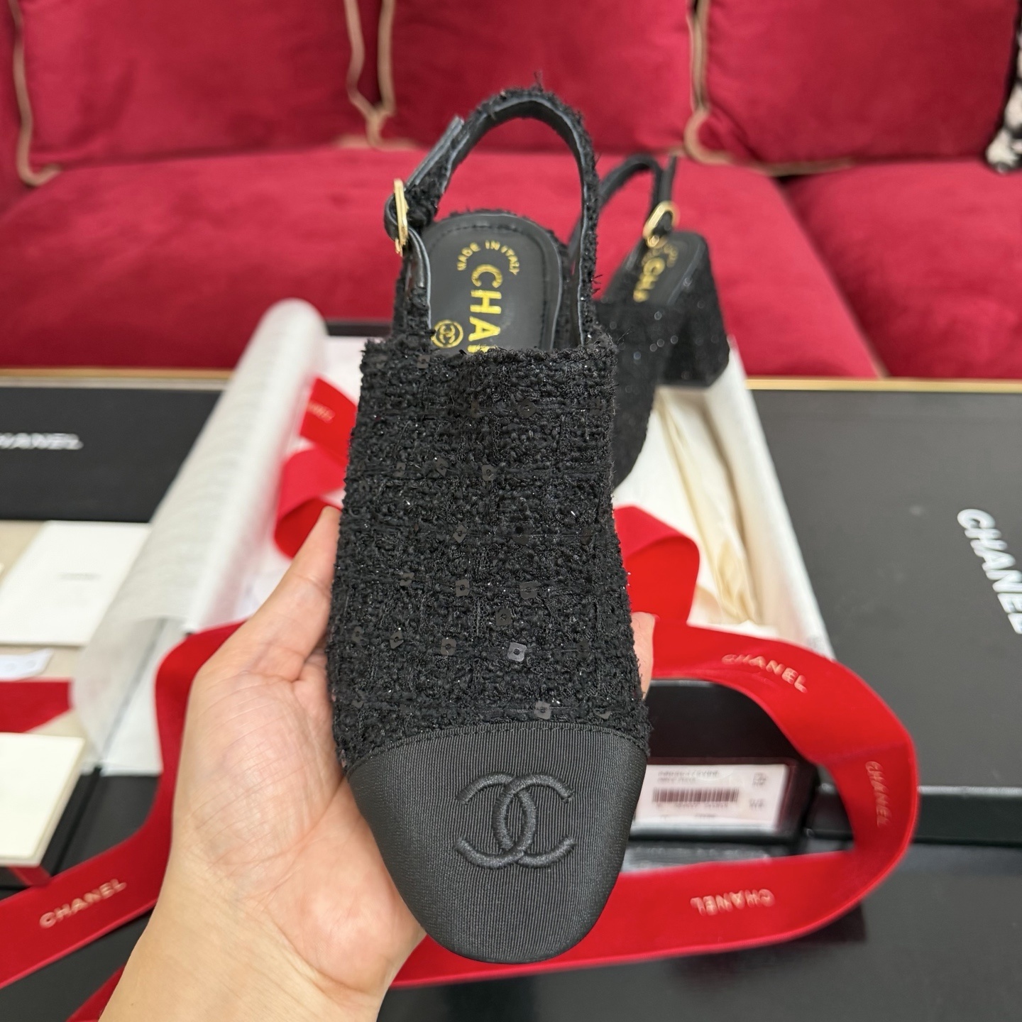 Pair of Chanel black tweed slingback pumps with sequins and CC logo on toe cap, displayed in original packaging with red ribbon. - Hình 3