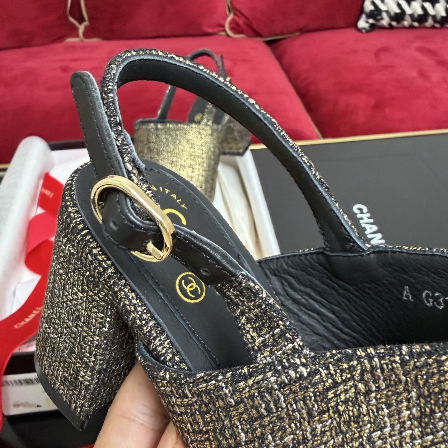 Pair of Chanel gold metallic tweed slingback pumps with black CC logo cap toe and block heel sitting in a gift box with red ribbon. - Hình 7