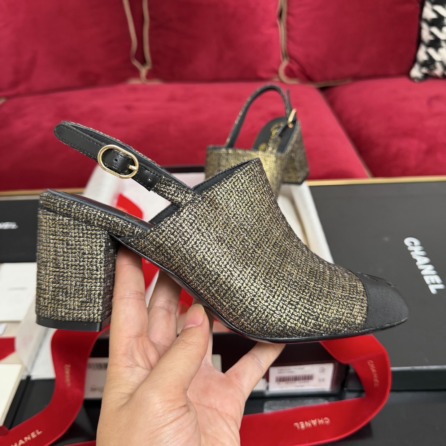 Pair of Chanel gold metallic tweed slingback pumps with black CC logo cap toe and block heel sitting in a gift box with red ribbon. - Hình 5