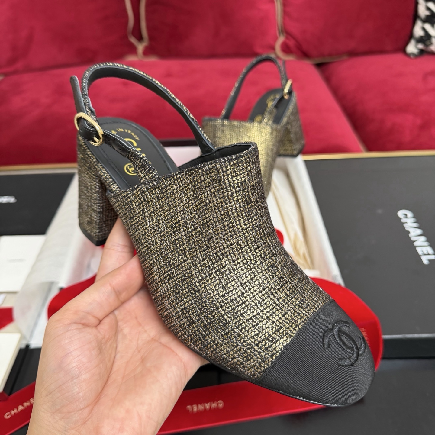 Pair of Chanel gold metallic tweed slingback pumps with black CC logo cap toe and block heel sitting in a gift box with red ribbon. - Hình 4