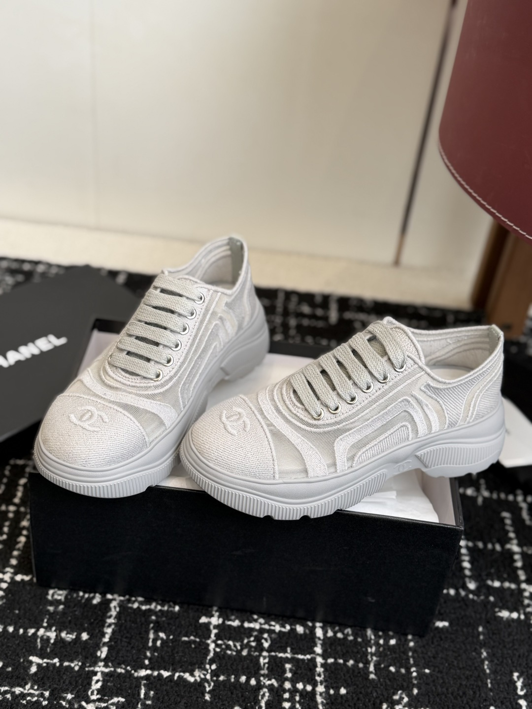 A pair of white Chanel mesh platform sneakers with the iconic interlocking CC logo on the toe cap. - Hình 3