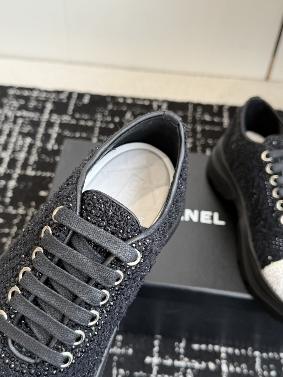 Pair of Chanel black and white sneakers covered in sparkling crystals with CC logo on the toe cap. - Hình 7