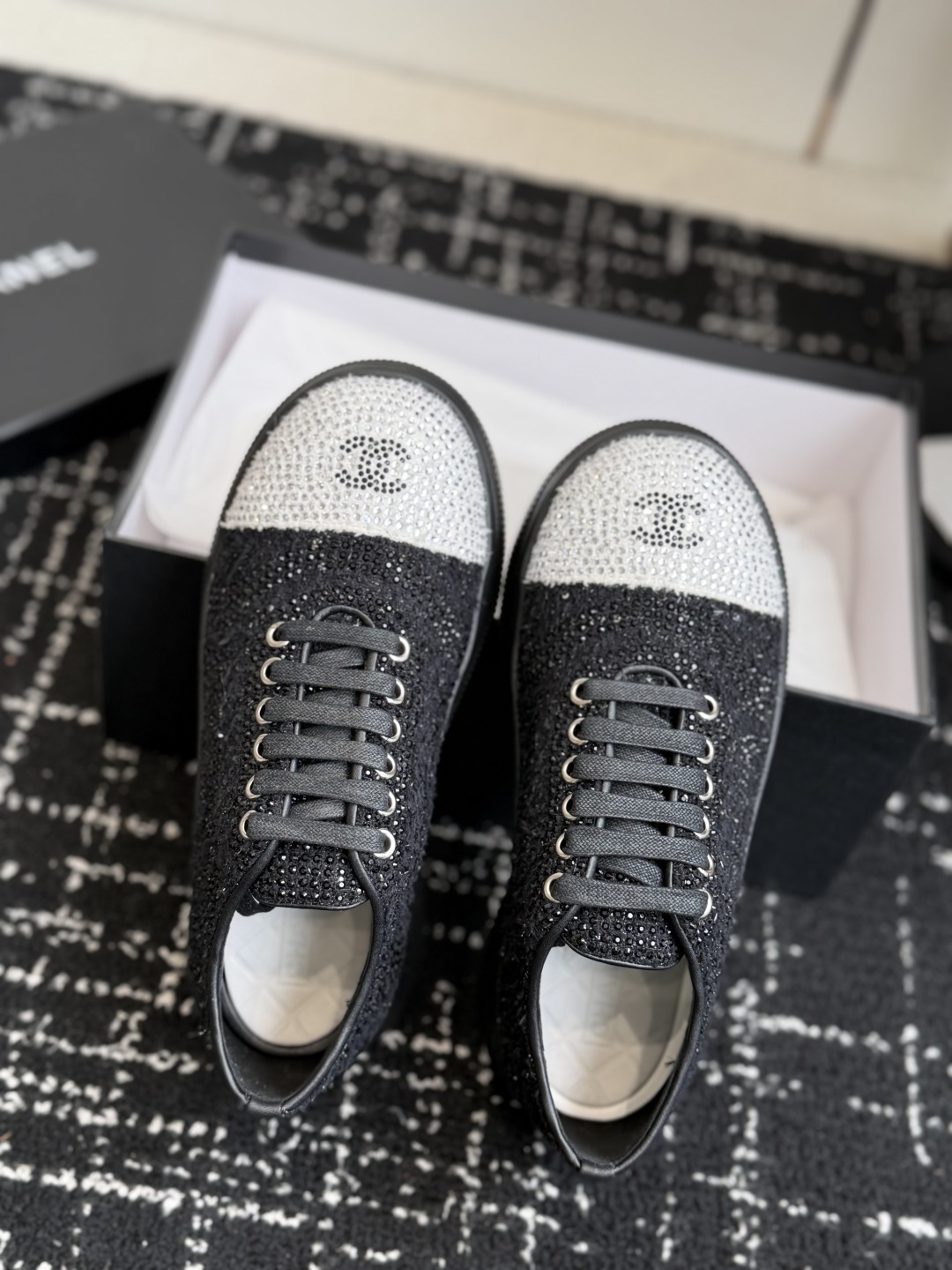 Pair of Chanel black and white sneakers covered in sparkling crystals with CC logo on the toe cap. - Hình 4