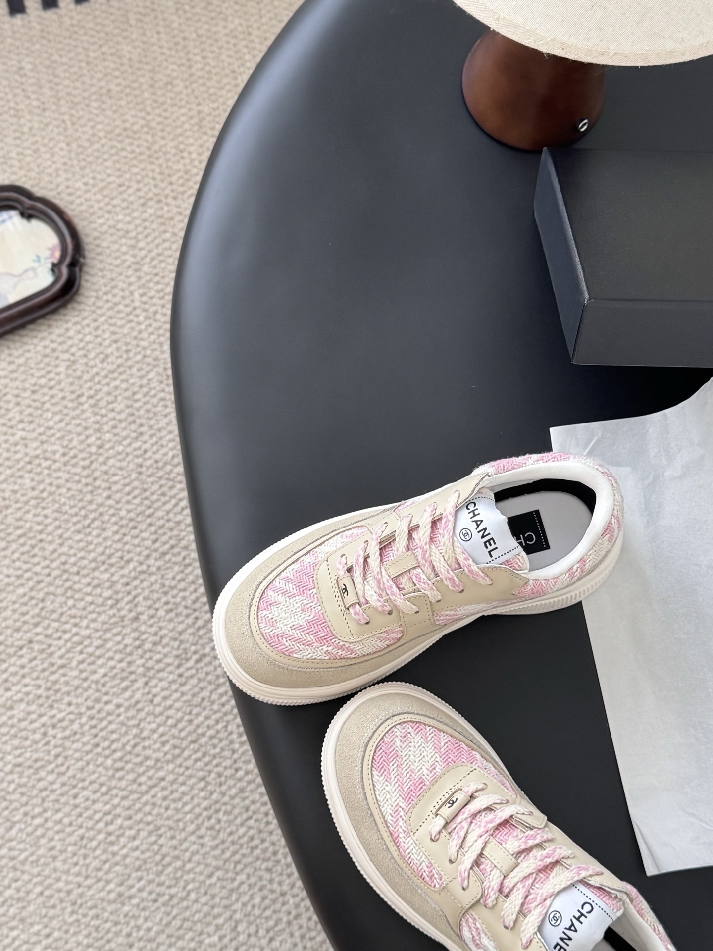 A pair of Chanel pink and white tweed sneakers with beige suede accents and a chunky white sole next to a black Chanel box. - Hình 6