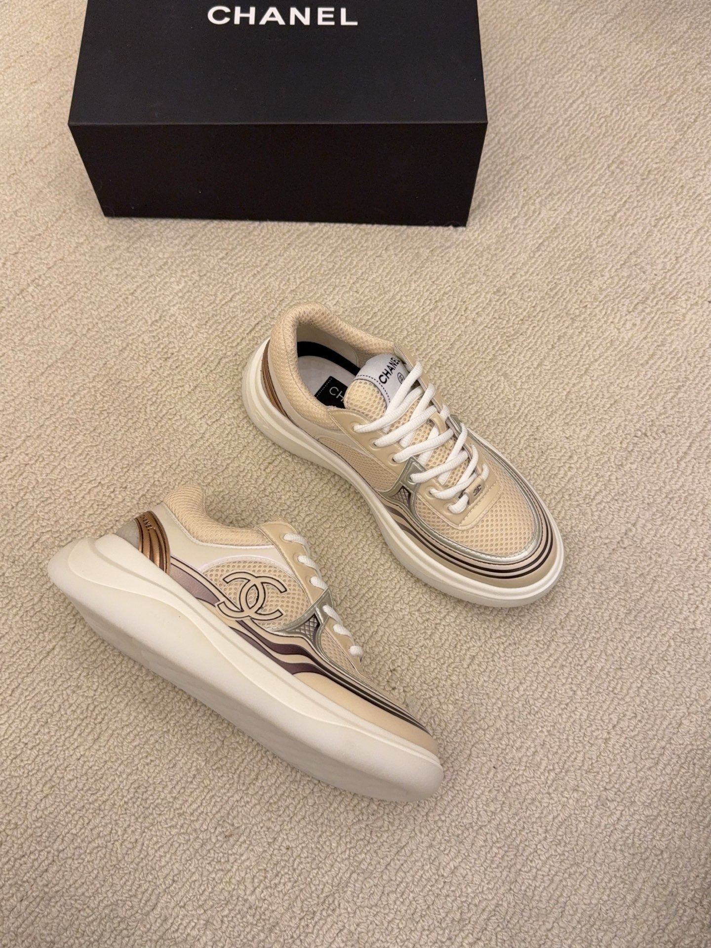 Two pairs of Chanel luxury mesh sneakers in beige and silver with chunky white soles and signature CC logo. - Hình 4