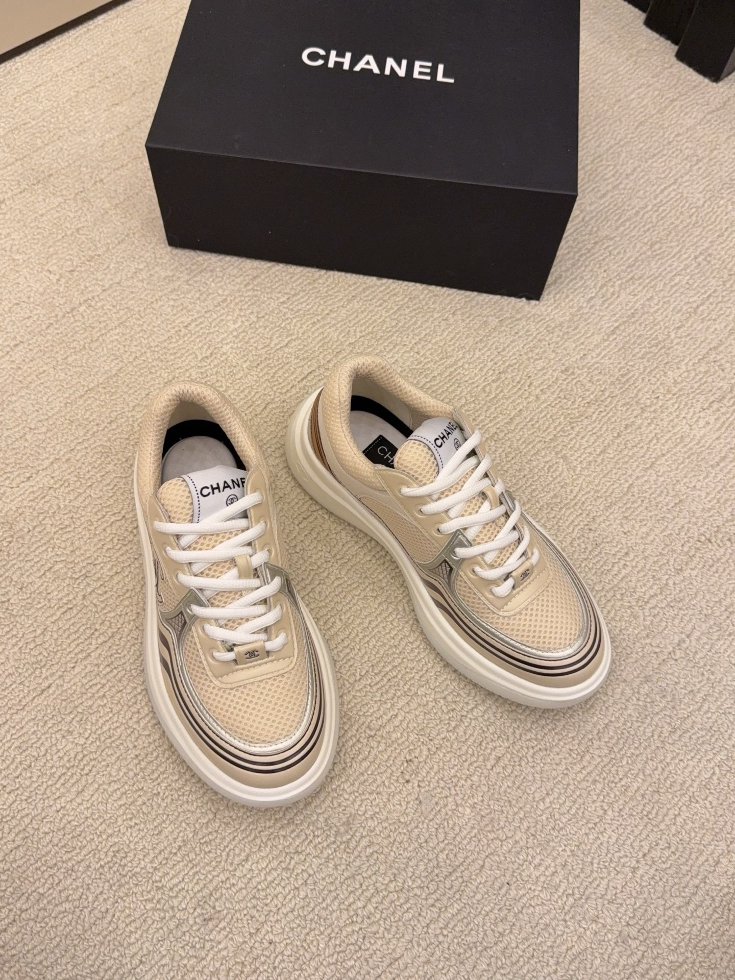 Two pairs of Chanel luxury mesh sneakers in beige and silver with chunky white soles and signature CC logo. - Hình 3