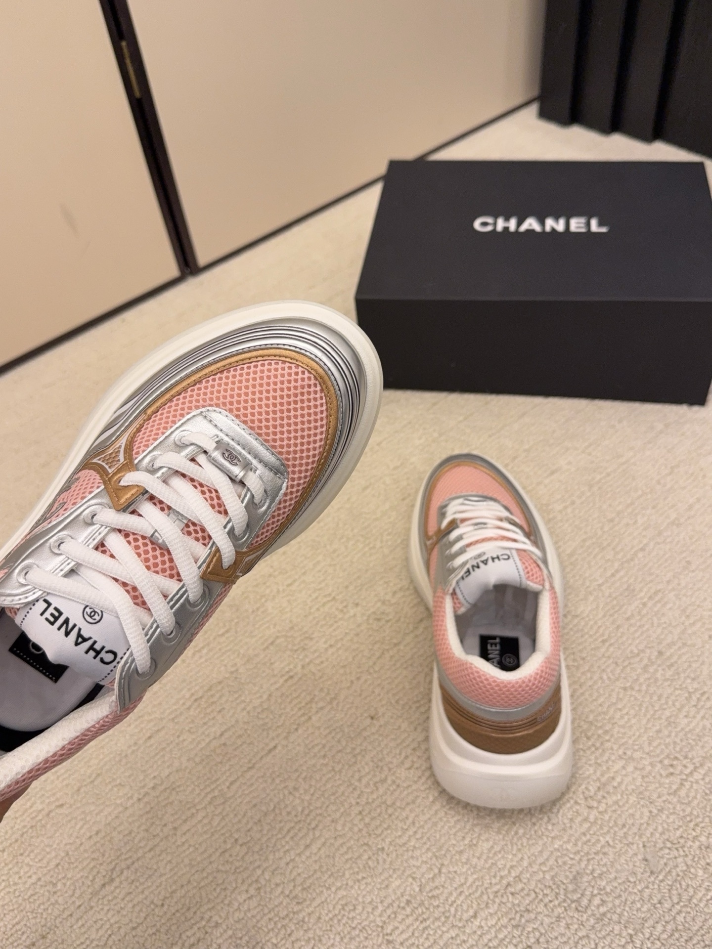 Pair of Chanel luxury sneakers in mint green and peach with metallic silver accents and mesh panels on a white platform sole. - Hình 9