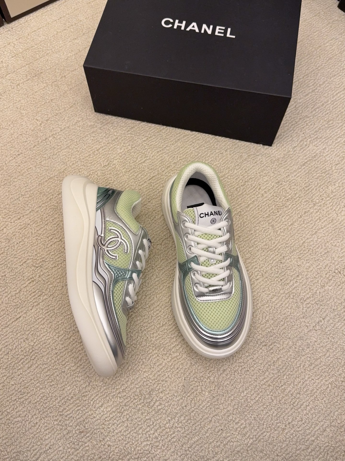 Pair of Chanel luxury sneakers in mint green and peach with metallic silver accents and mesh panels on a white platform sole. - Hình 3