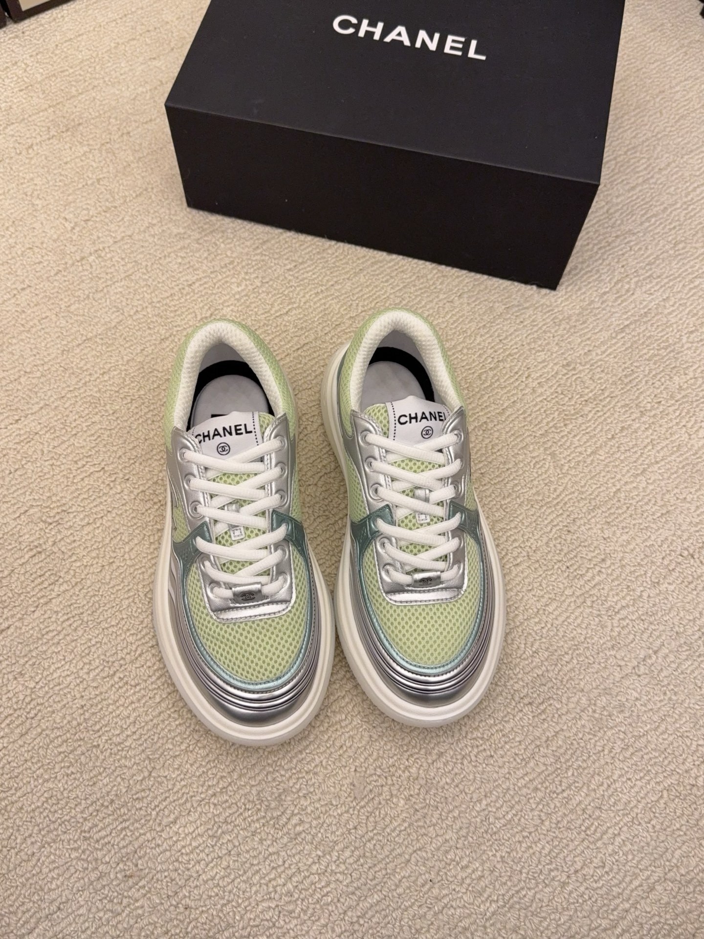 Pair of Chanel luxury sneakers in mint green and peach with metallic silver accents and mesh panels on a white platform sole. - Hình 2