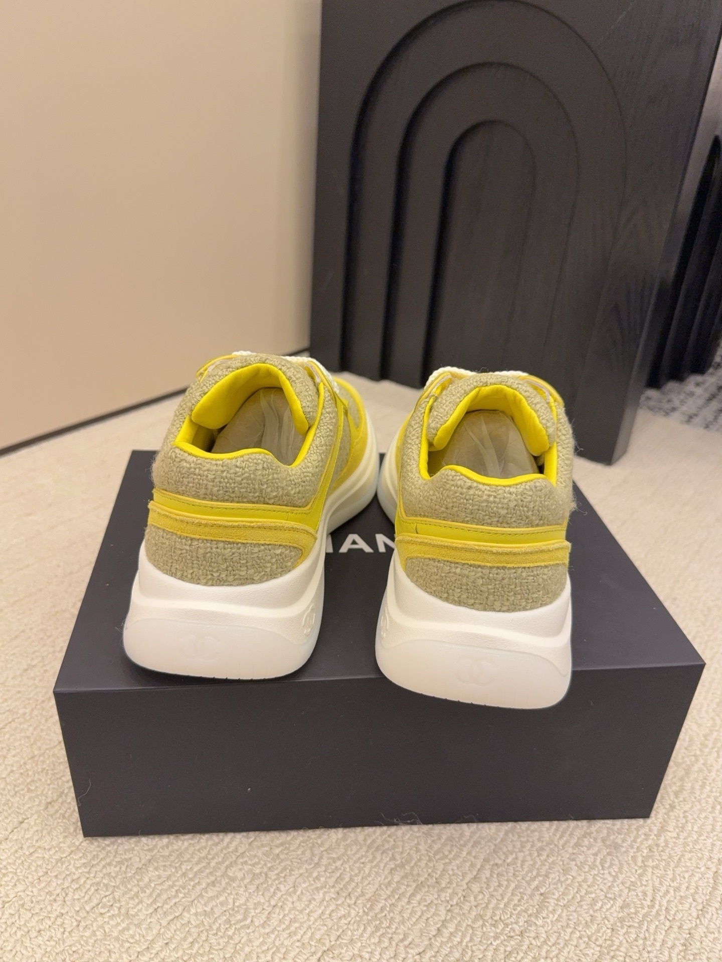 Pair of luxury yellow tweed and suede sneakers with white chunky soles and CC logo on a black box - Hình 7