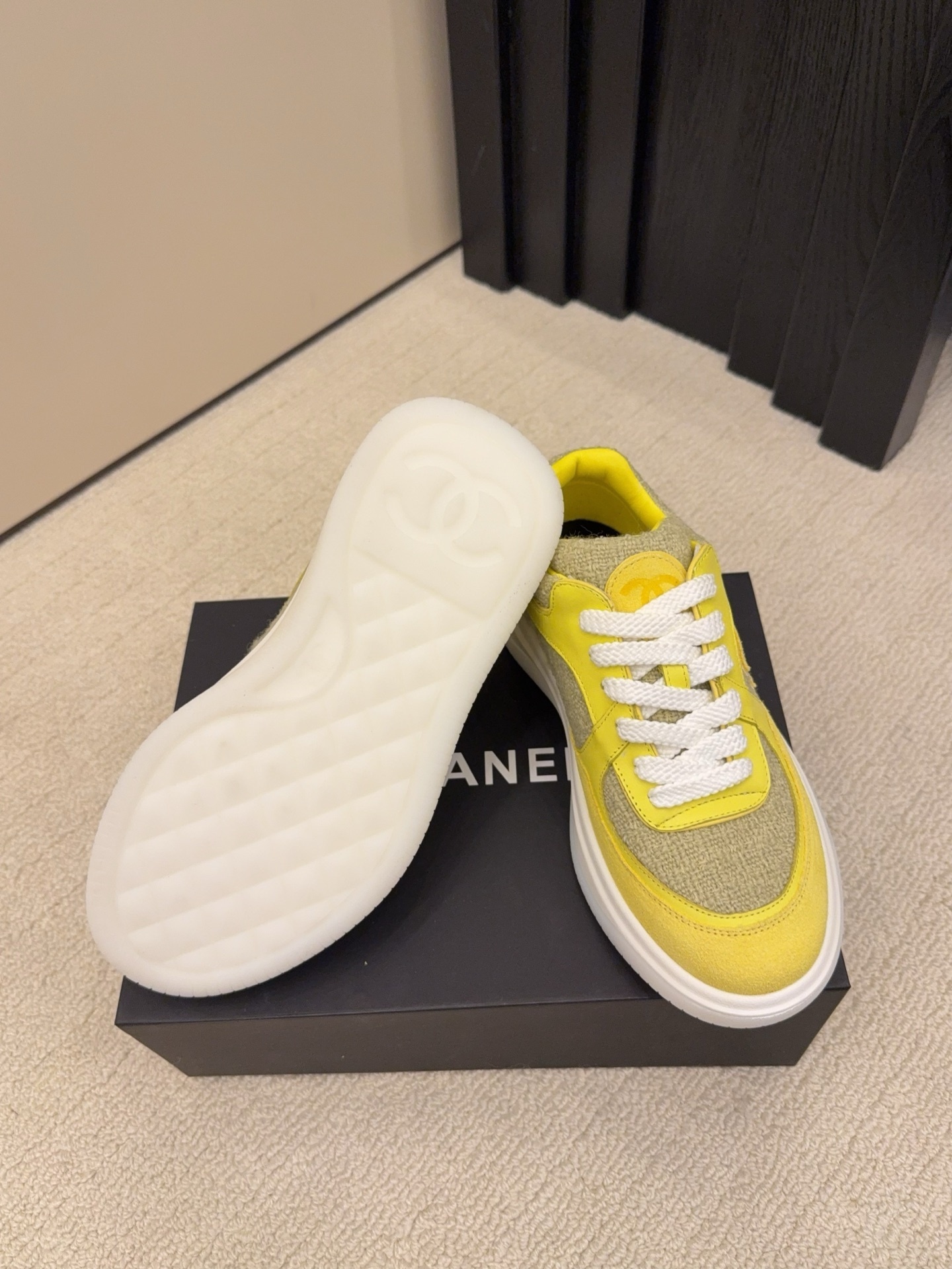 Pair of luxury yellow tweed and suede sneakers with white chunky soles and CC logo on a black box - Hình 5