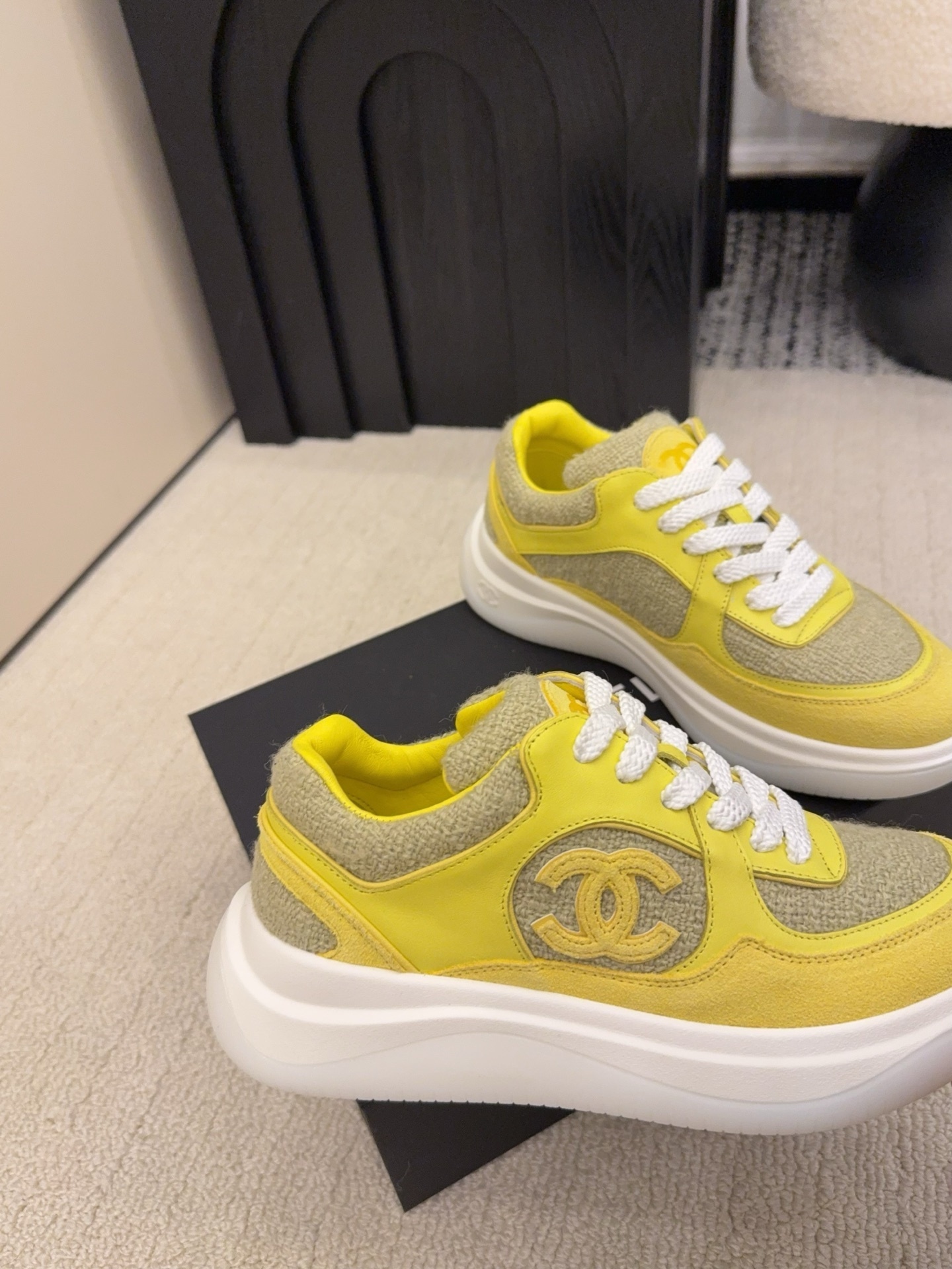 Pair of luxury yellow tweed and suede sneakers with white chunky soles and CC logo on a black box - Hình 4