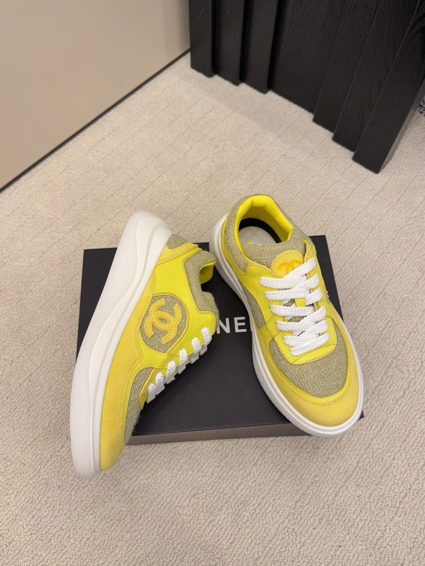 Pair of luxury yellow tweed and suede sneakers with white chunky soles and CC logo on a black box - Hình 3