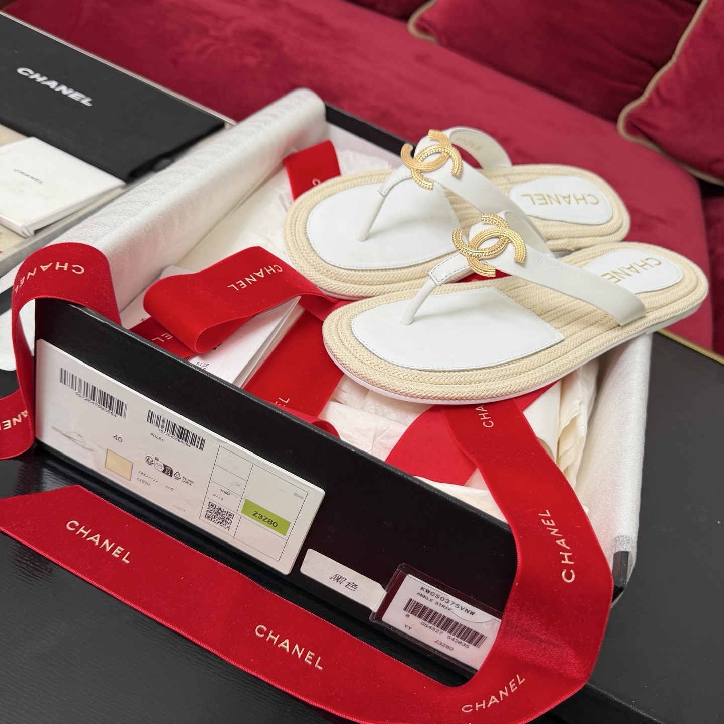 Luxury Chanel white leather thong sandals with gold interlocking CC logo and woven espadrille soles in original packaging. - Hình 2