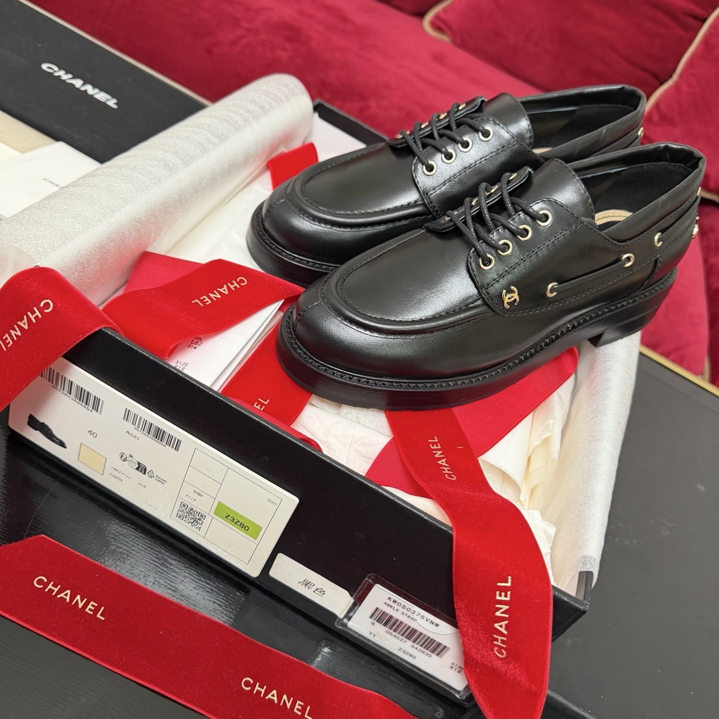 Pair of black Chanel leather lace-up loafers with gold-tone eyelets and CC logo in original box with red ribbon - Hình 2