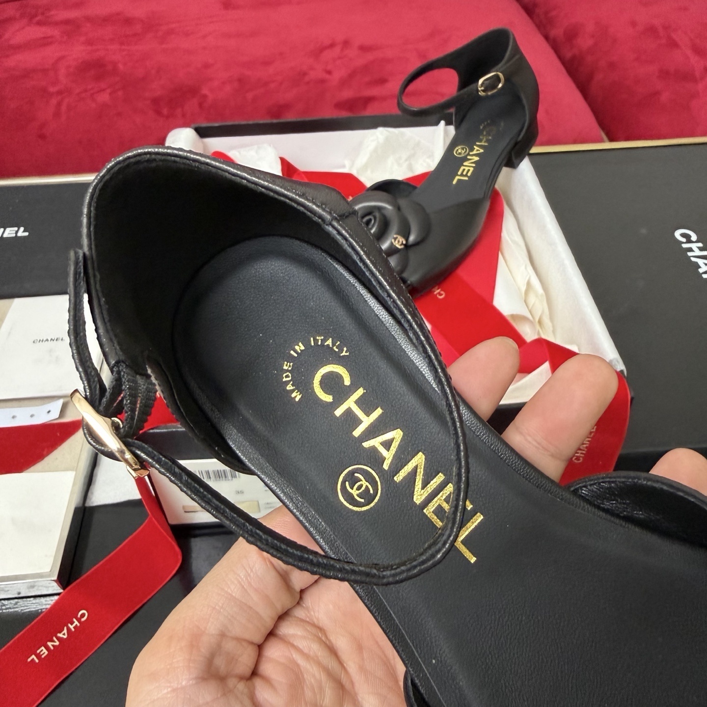 Pair of black Chanel ankle strap flats featuring a large camellia flower and patent leather toe cap in a luxury gift box. - Hình 8