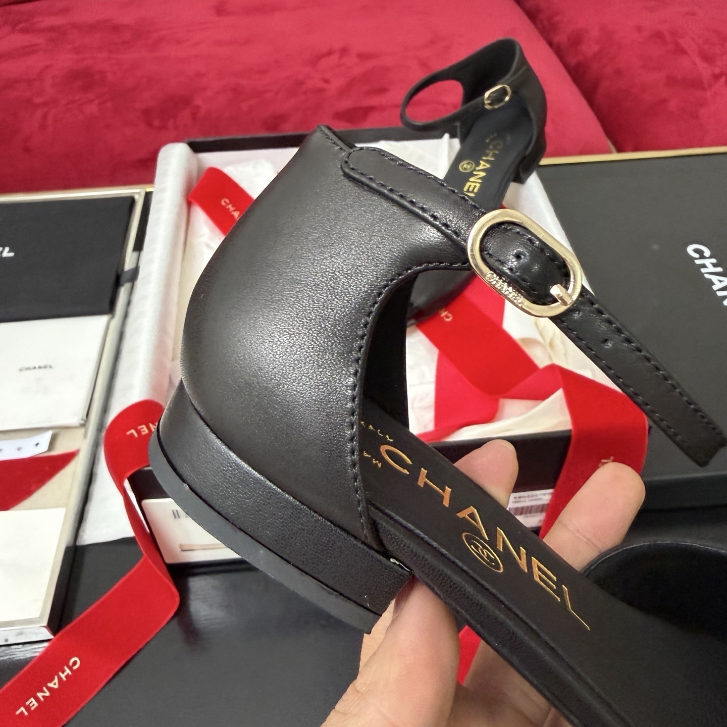 Pair of black Chanel ankle strap flats featuring a large camellia flower and patent leather toe cap in a luxury gift box. - Hình 7