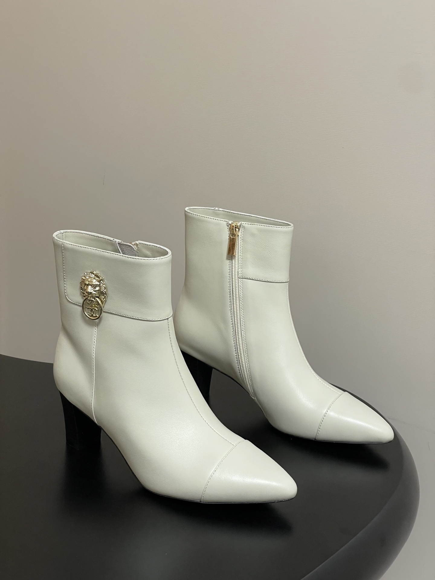Elegant White Leather Ankle Boots with Gold Lion Detail