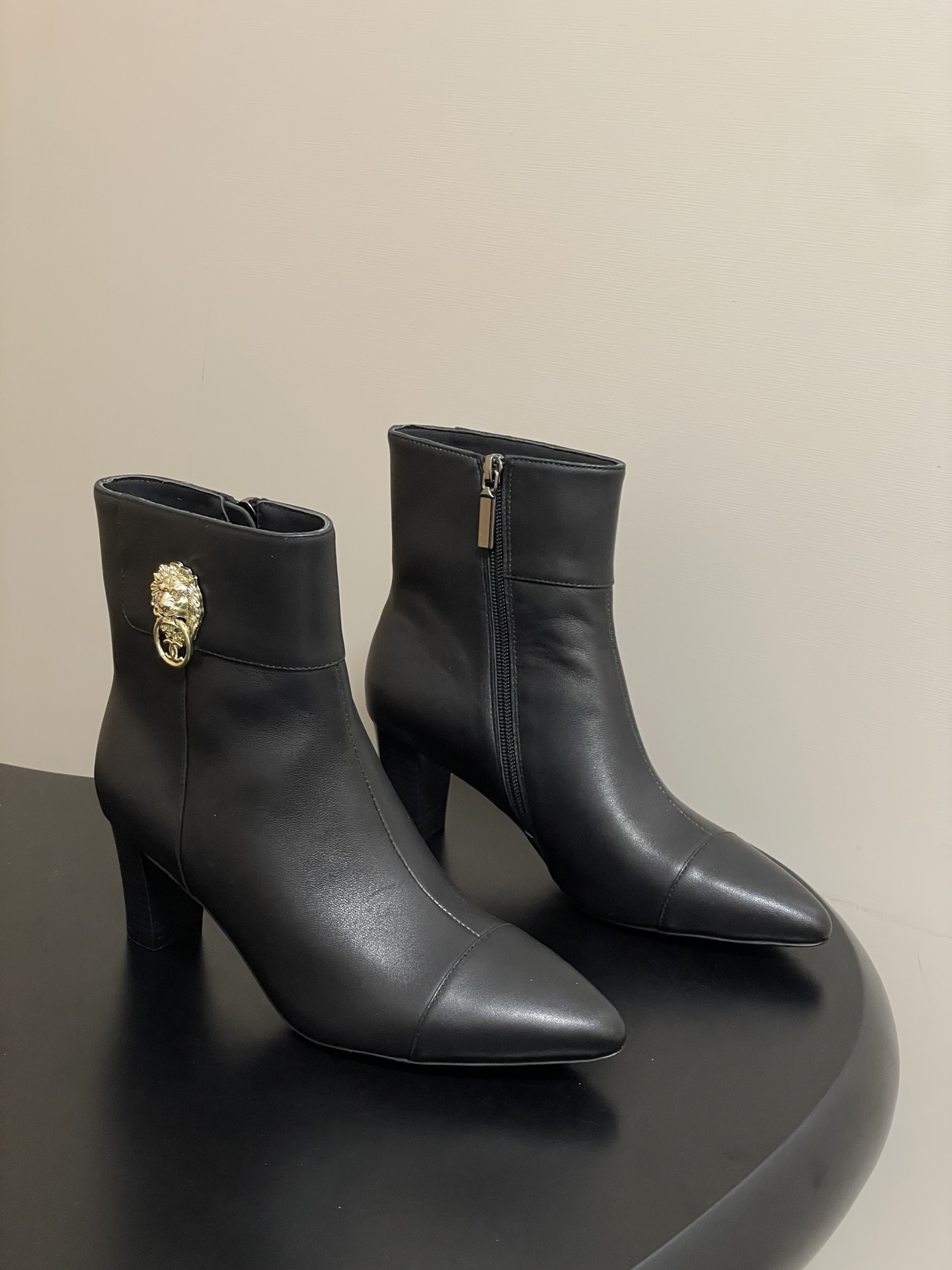 Elegant Black Leather Ankle Boots with Gold Lion Head Detail