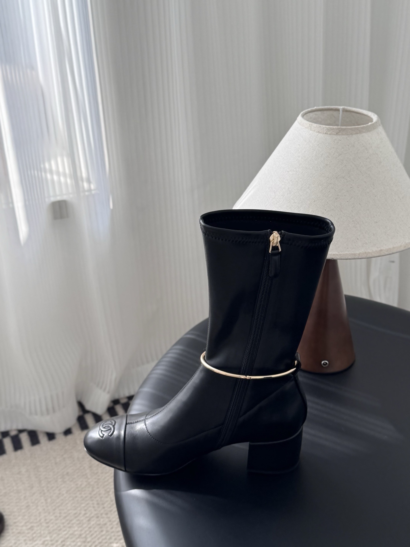 Elegant Black Leather Mid-Calf Boots with Gold Charm Detail