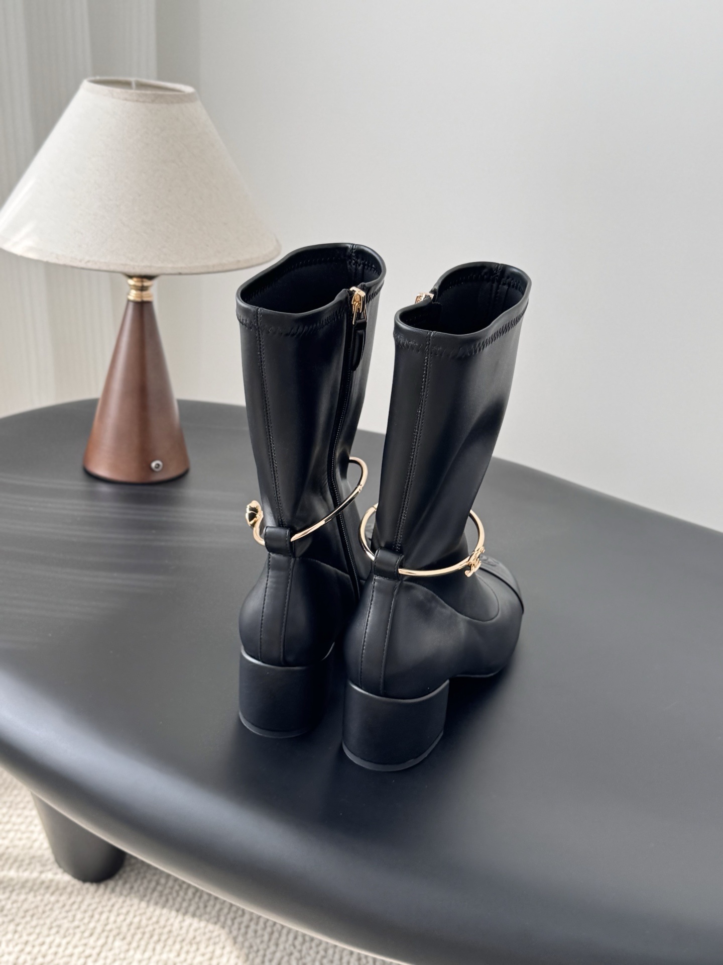 Elegant Black Leather Mid-Calf Boots with Gold Charm Detail