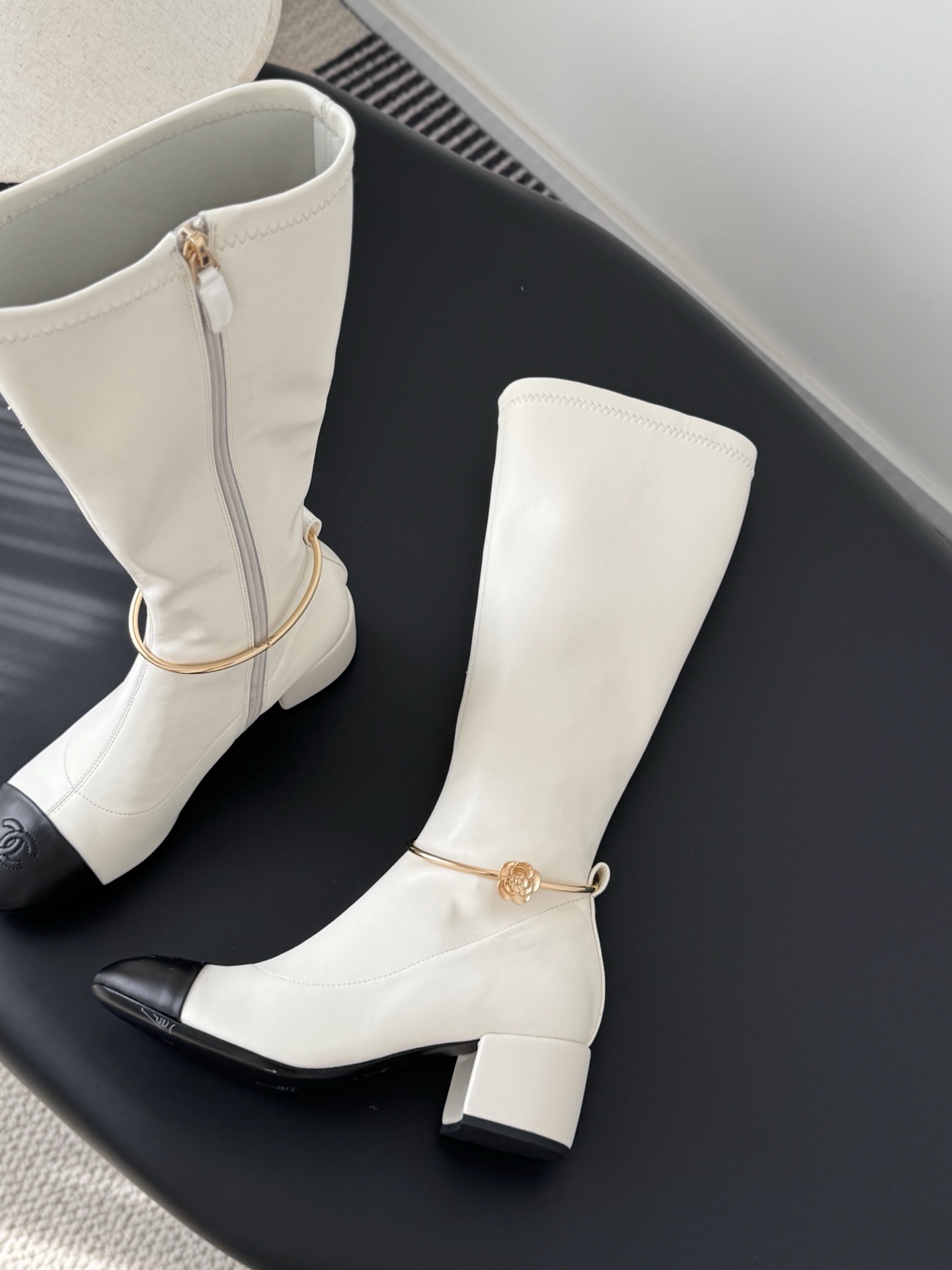 Elegant White Knee-High Boots with Black Toe Cap & Gold Detail