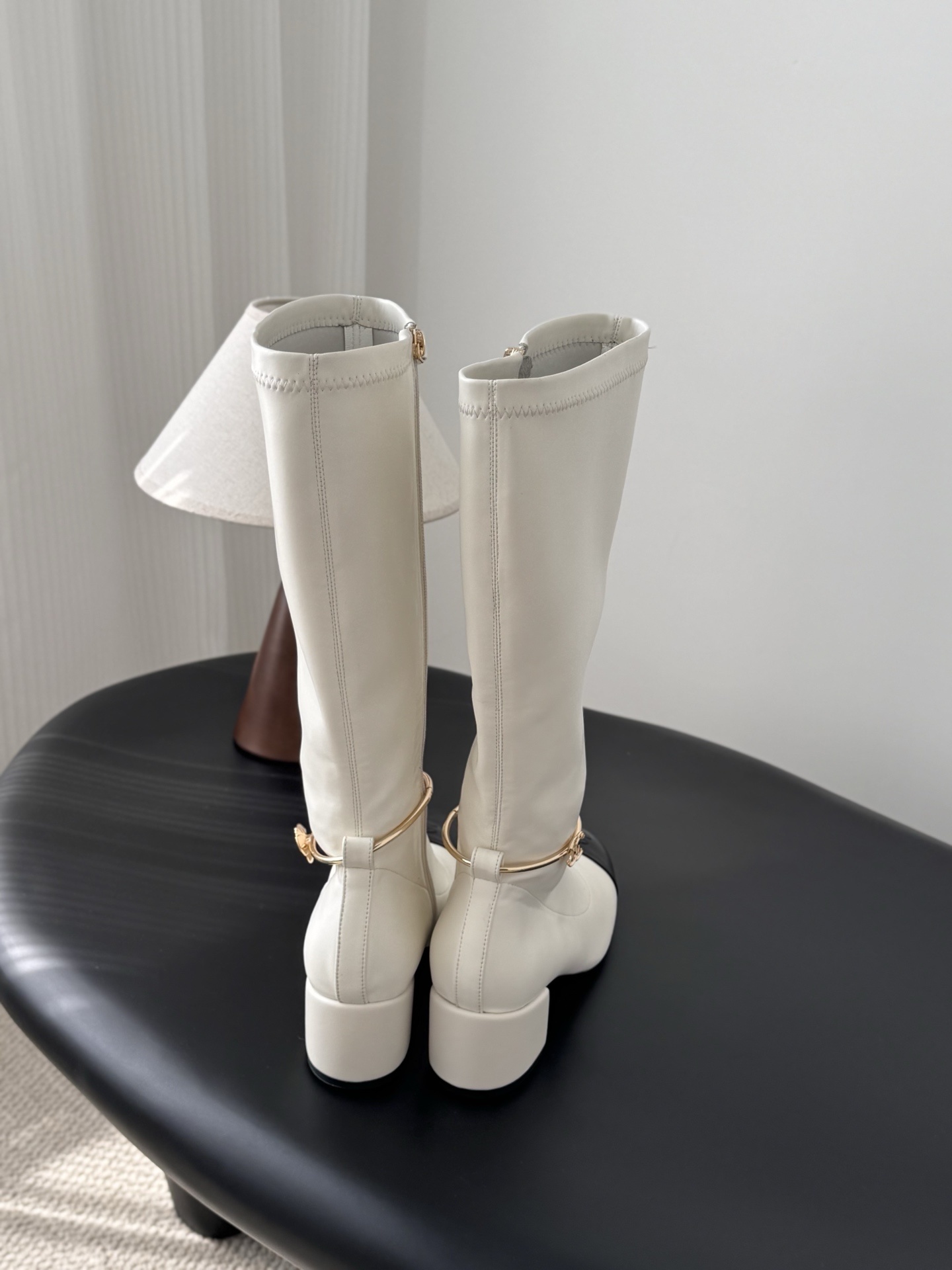 Elegant White Knee-High Boots with Black Toe Cap & Gold Detail