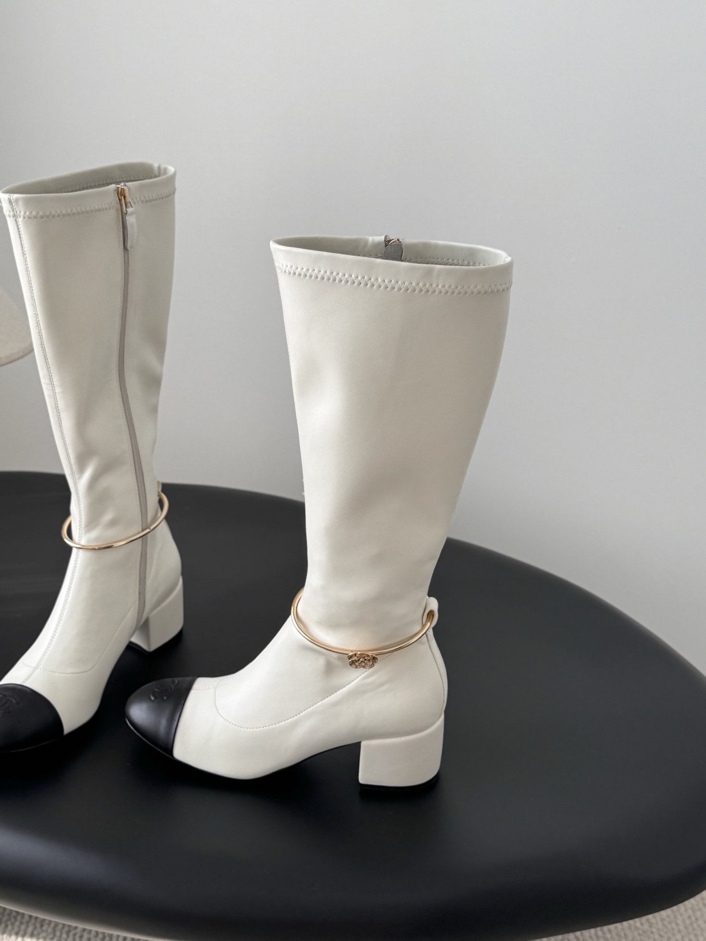Elegant White Knee-High Boots with Black Toe Cap & Gold Detail