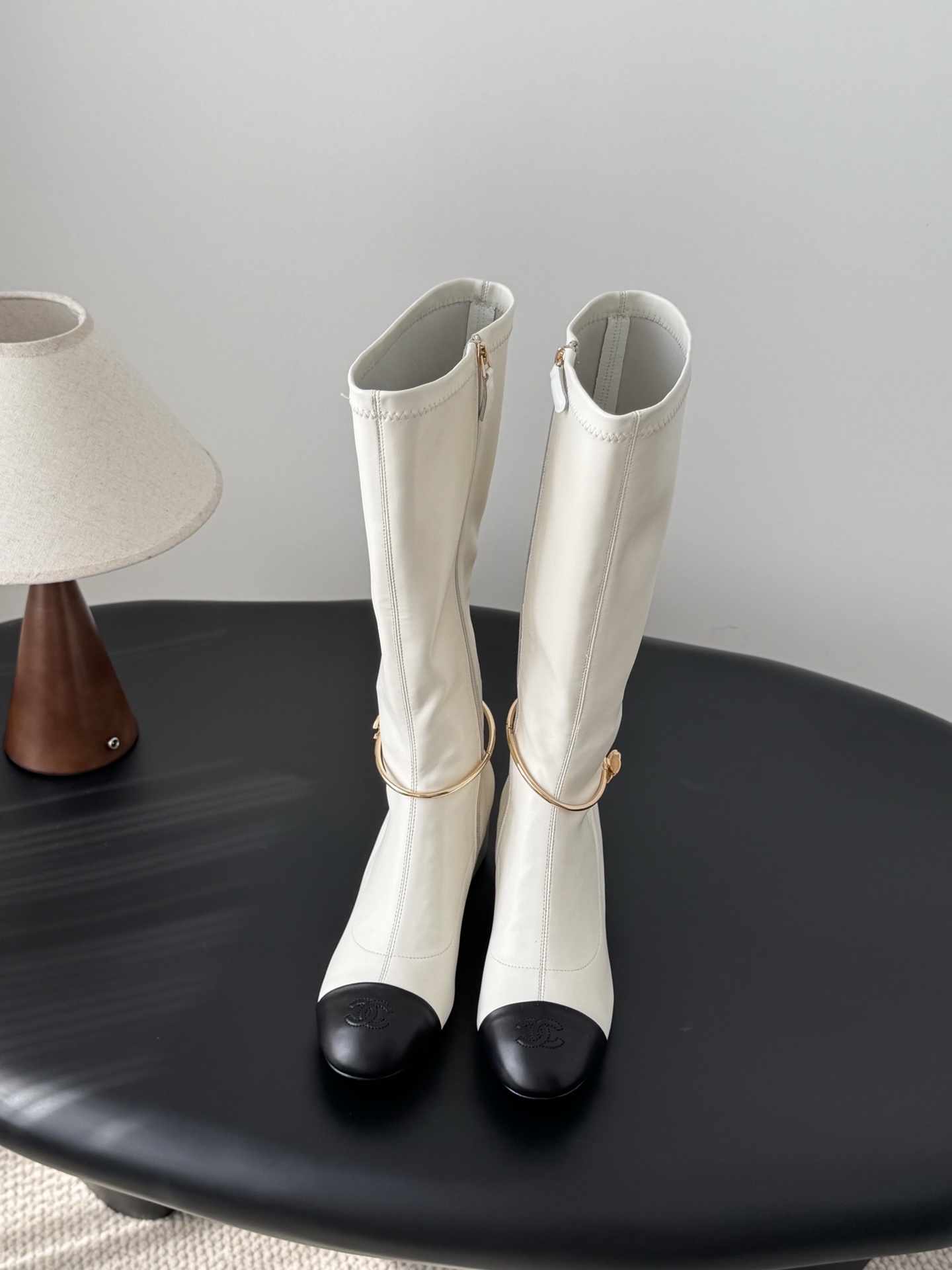 Elegant White Knee-High Boots with Black Toe Cap & Gold Detail