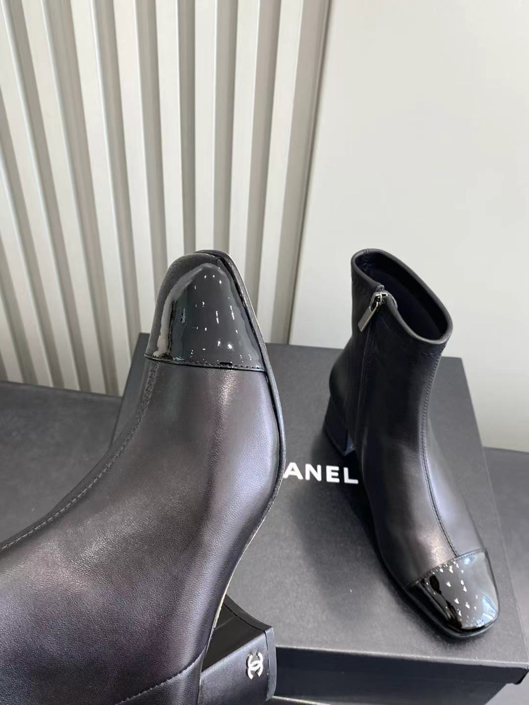 Elegant Black Leather Ankle Boots with Patent Cap Toe & Logo Heel