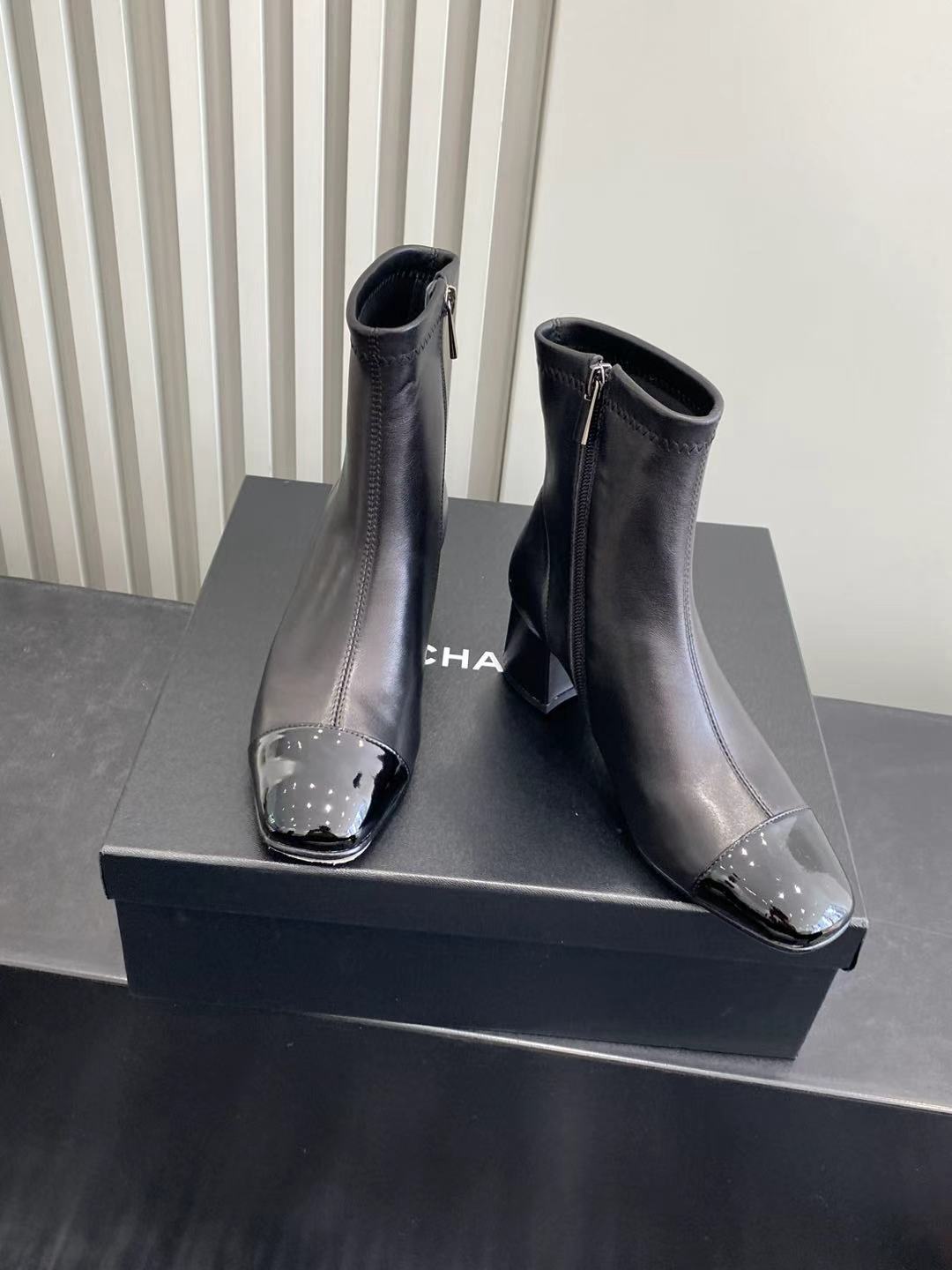 Elegant Black Leather Ankle Boots with Patent Cap Toe & Logo Heel