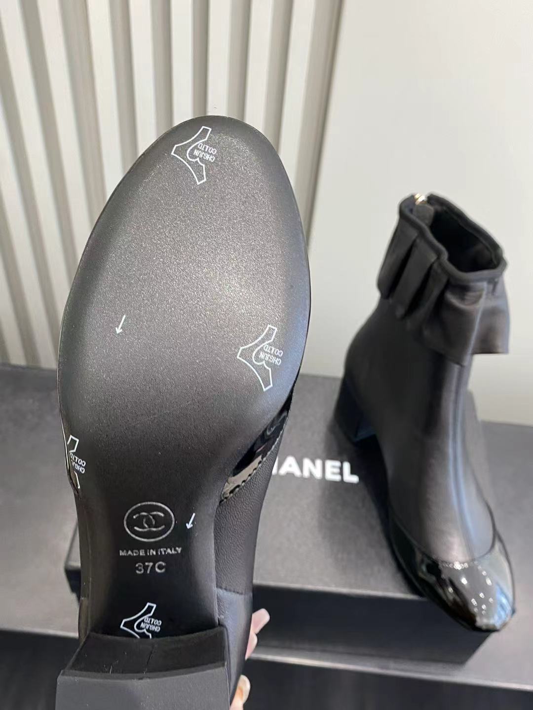 Elegant Black Leather Ruffle Ankle Boots with Patent Cap Toe