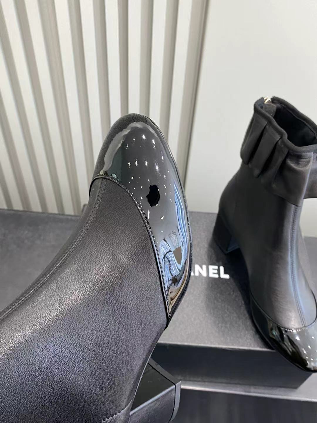 Elegant Black Leather Ruffle Ankle Boots with Patent Cap Toe