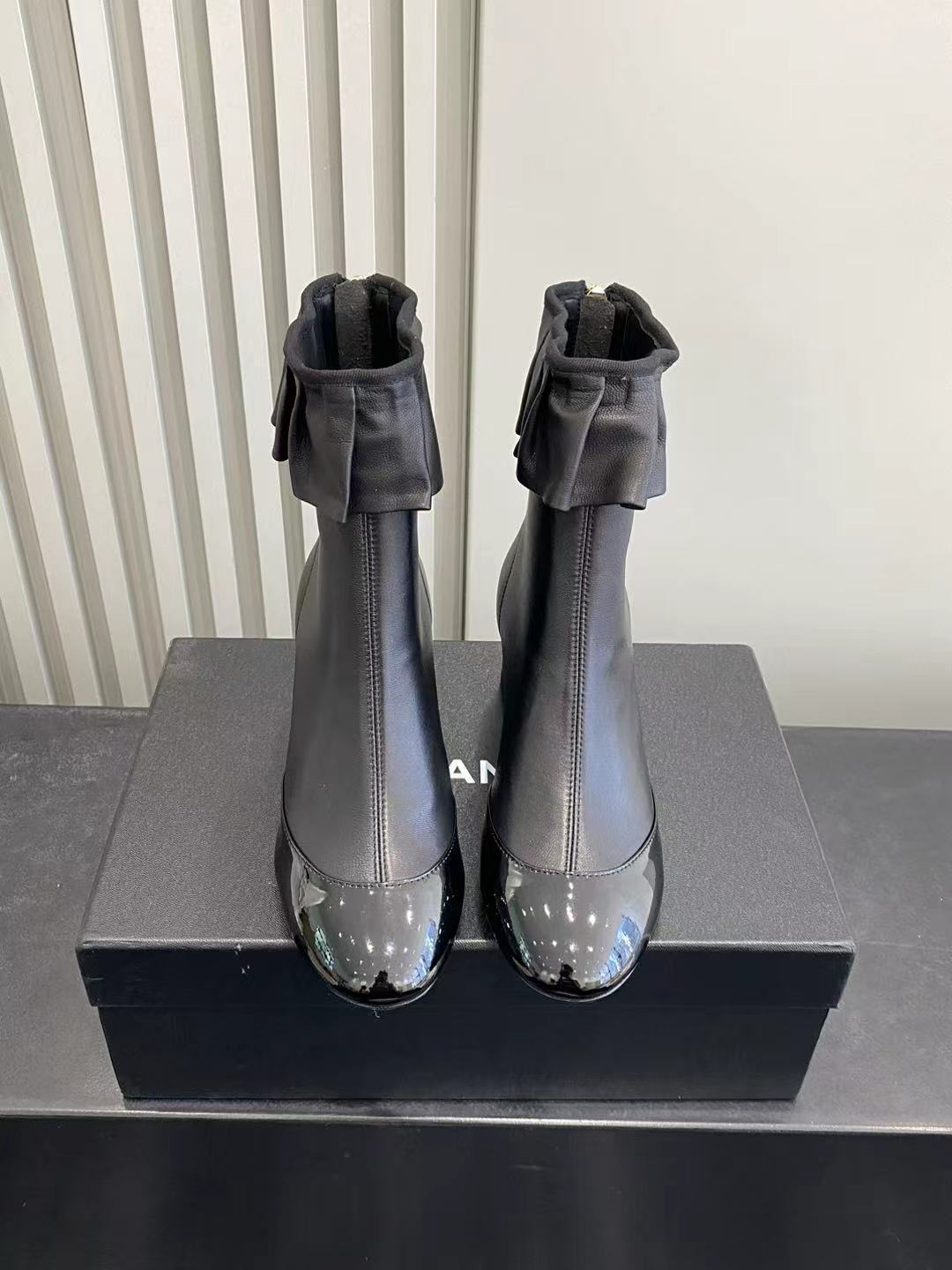 Elegant Black Leather Ruffle Ankle Boots with Patent Cap Toe