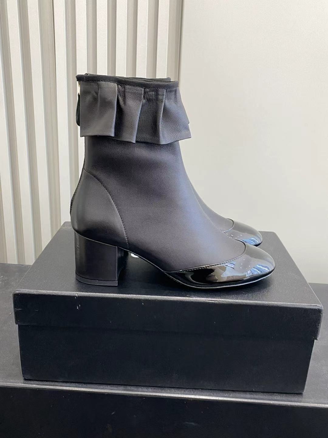 Elegant Black Leather Ruffle Ankle Boots with Patent Cap Toe