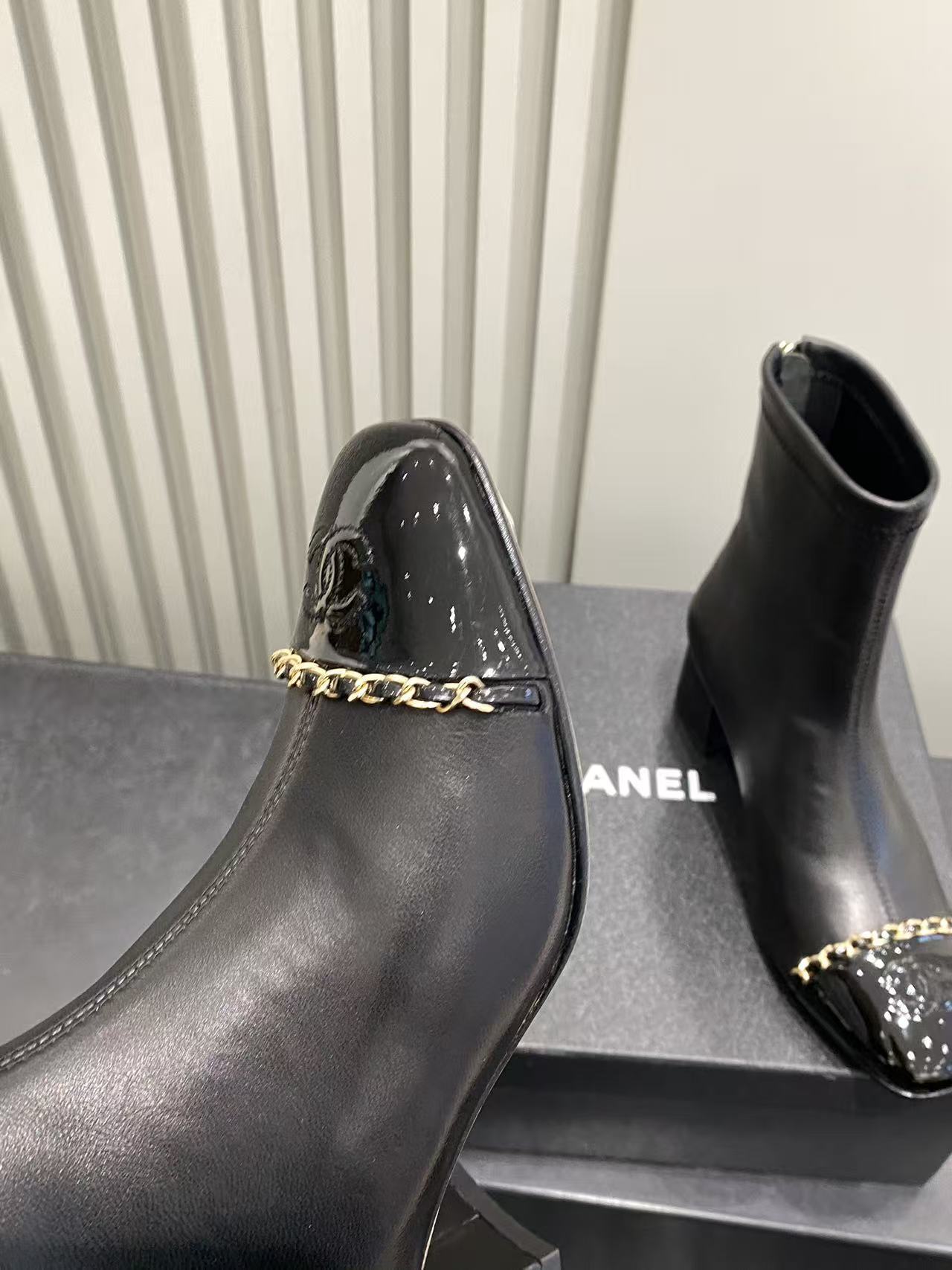 Luxury Black Leather Ankle Boots with Patent Toe & Gold Chain