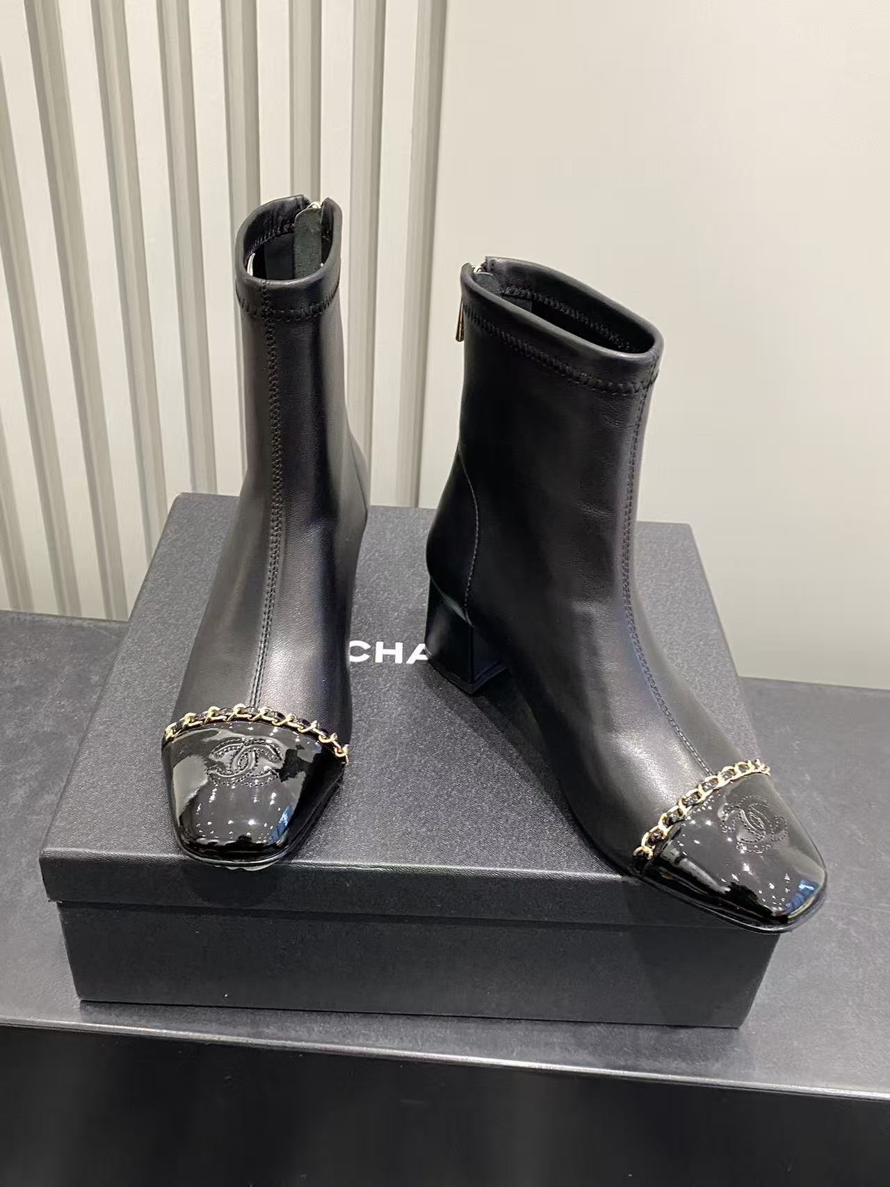 Luxury Black Leather Ankle Boots with Patent Toe & Gold Chain