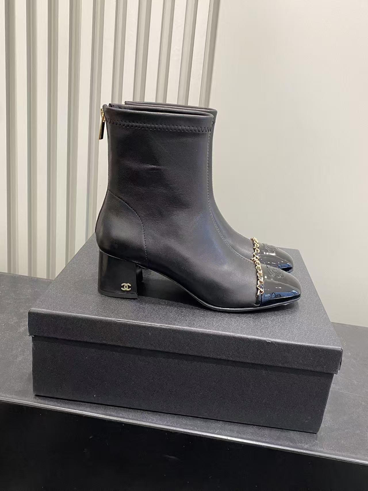 Luxury Black Leather Ankle Boots with Patent Toe & Gold Chain