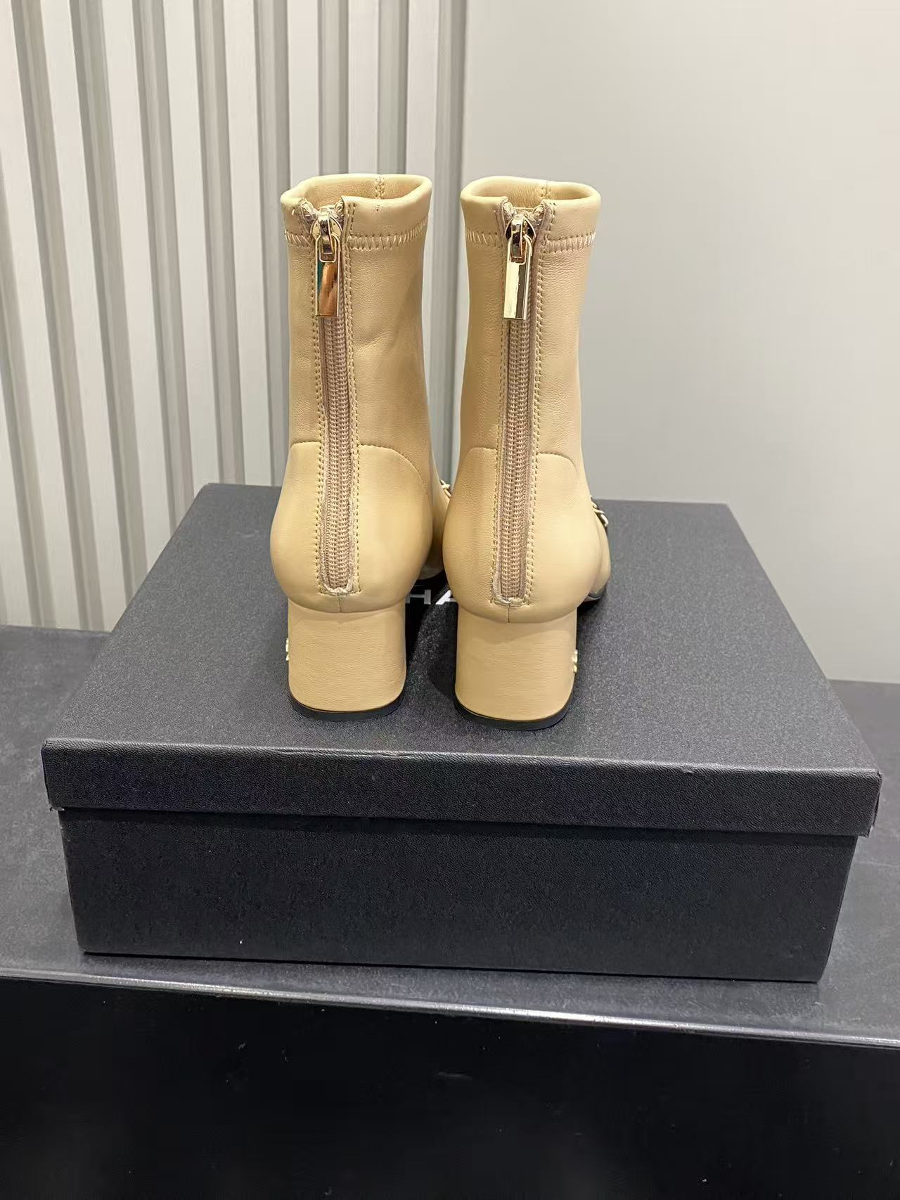 Luxury Beige Leather Cap Toe Ankle Boots with Gold Chain Detail