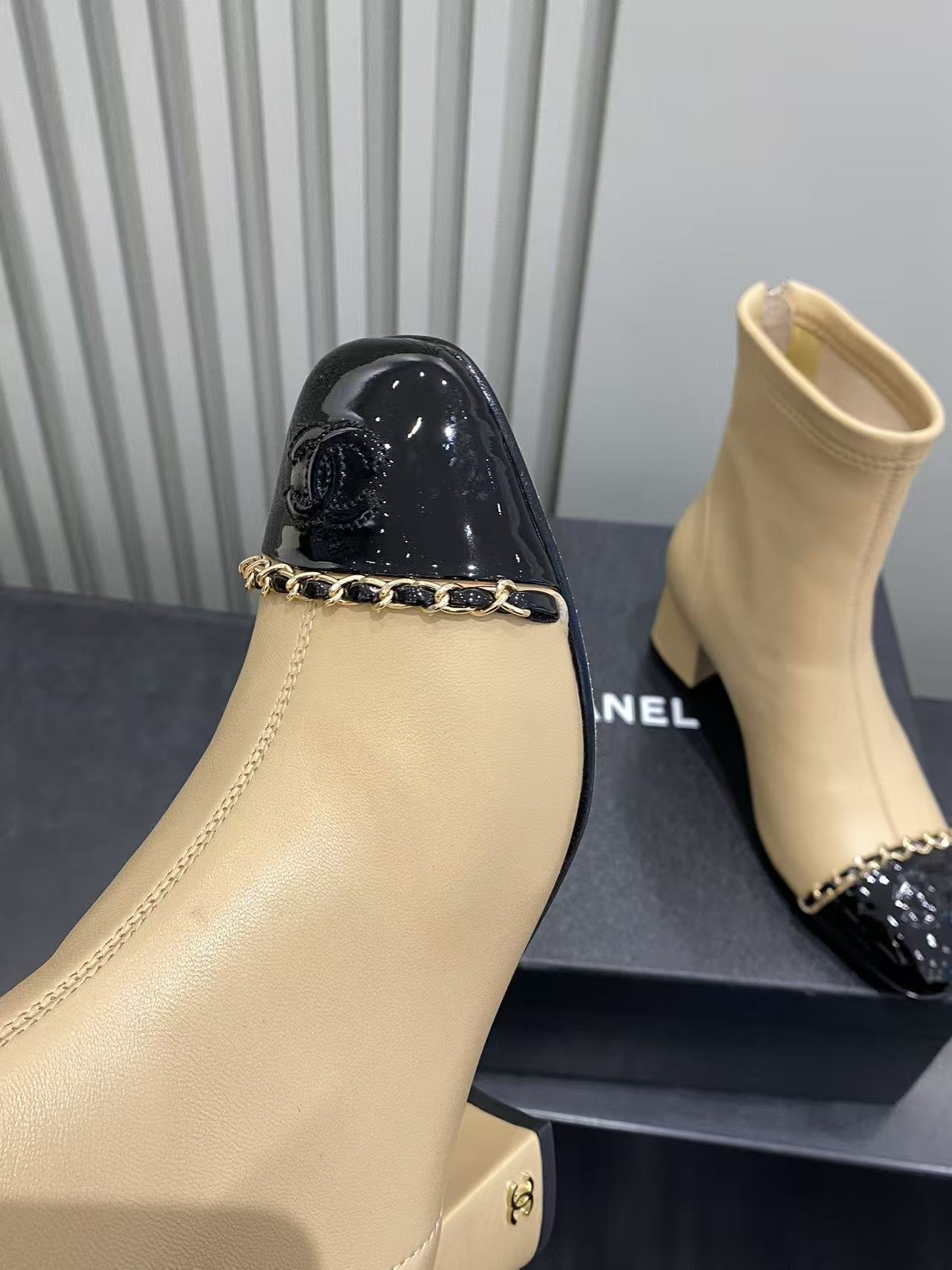 Luxury Beige Leather Cap Toe Ankle Boots with Gold Chain Detail