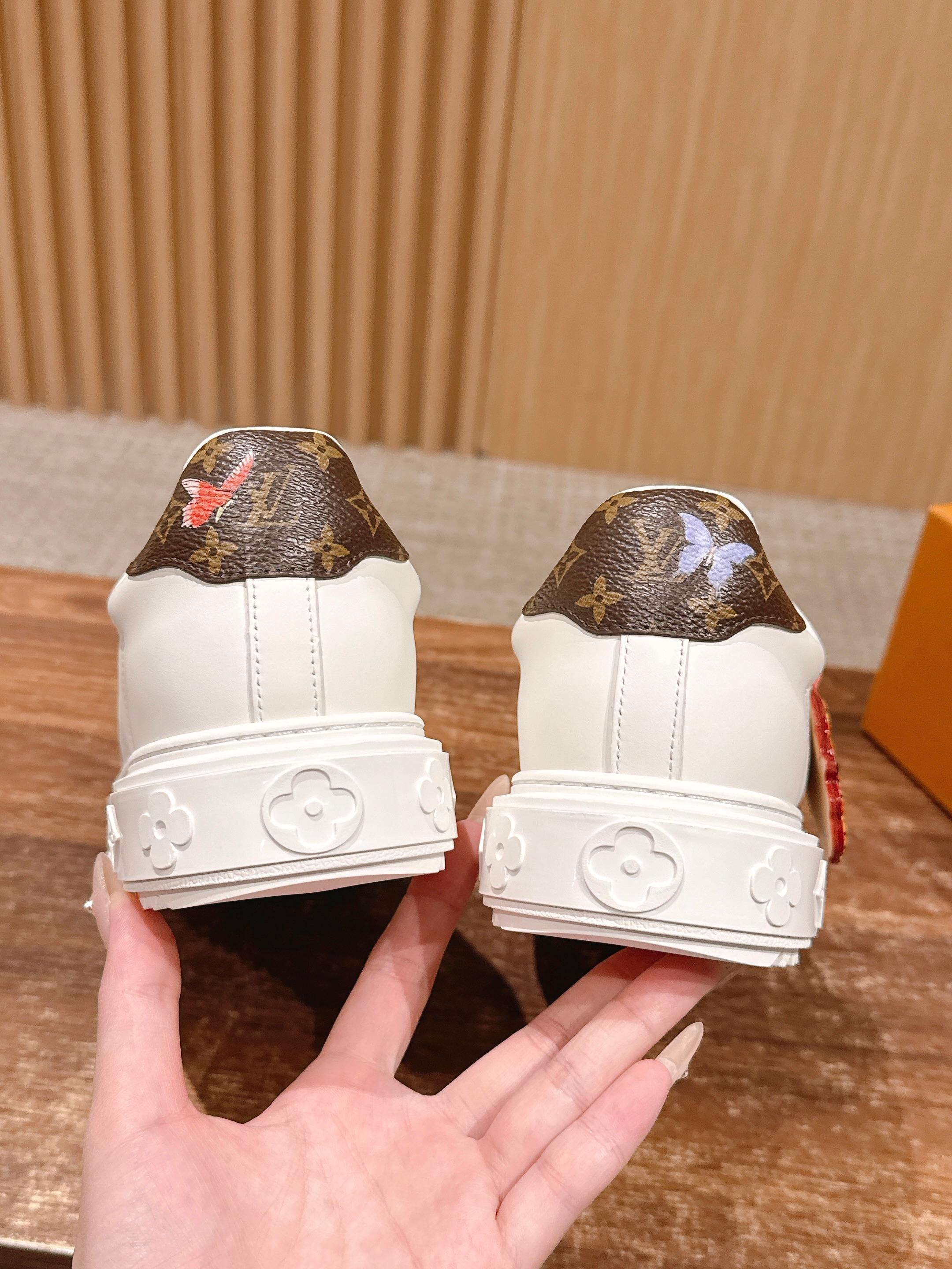 Louis Vuitton Women's White Leather Sneakers with Gold Accents