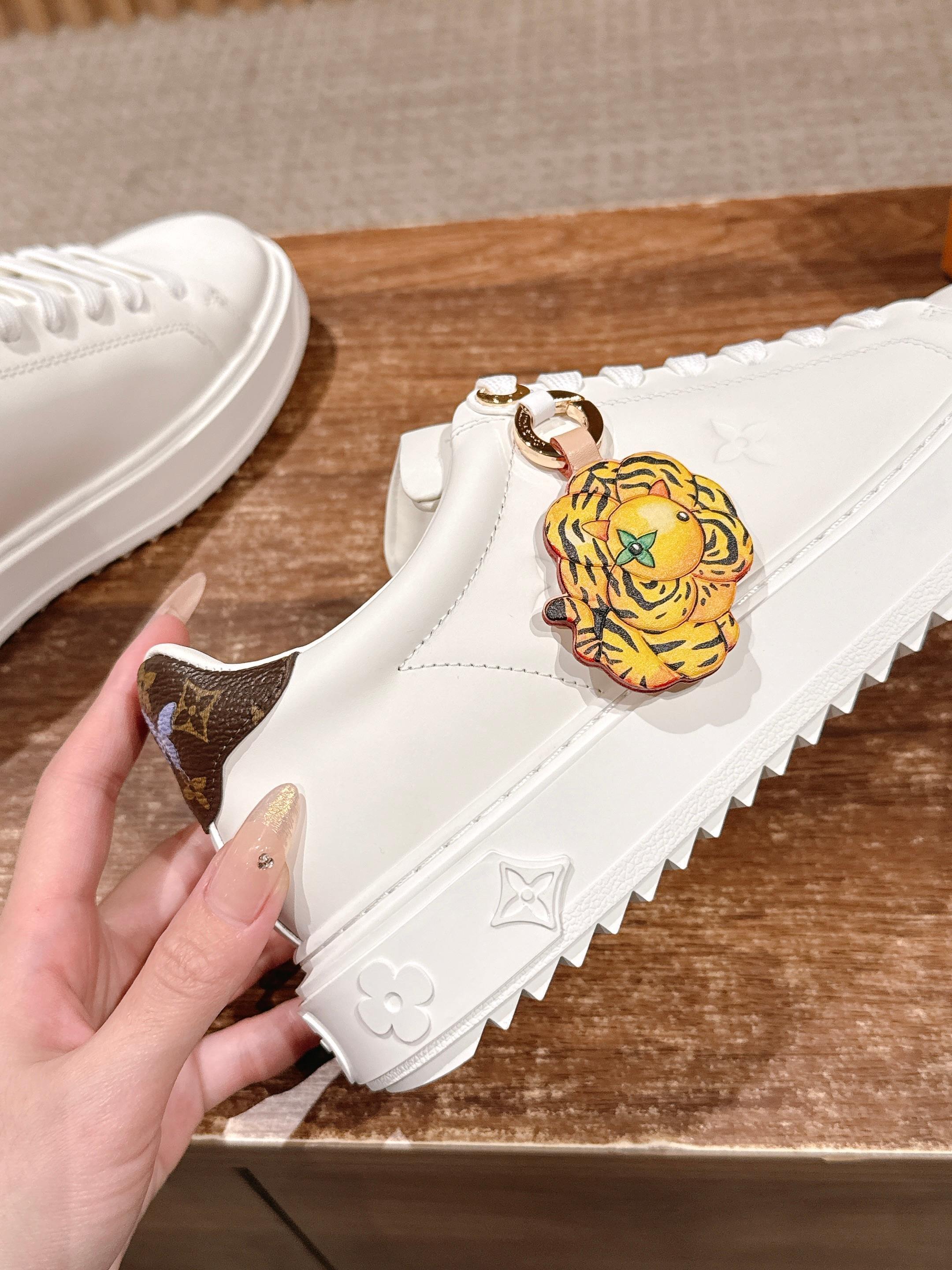 Louis Vuitton Women's White Leather Sneakers with Gold Accents