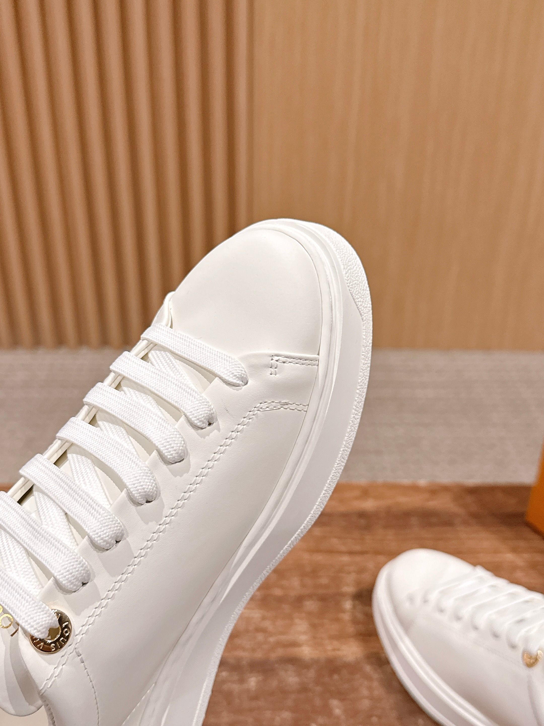 Louis Vuitton Women's White Leather Sneakers with Gold Accents
